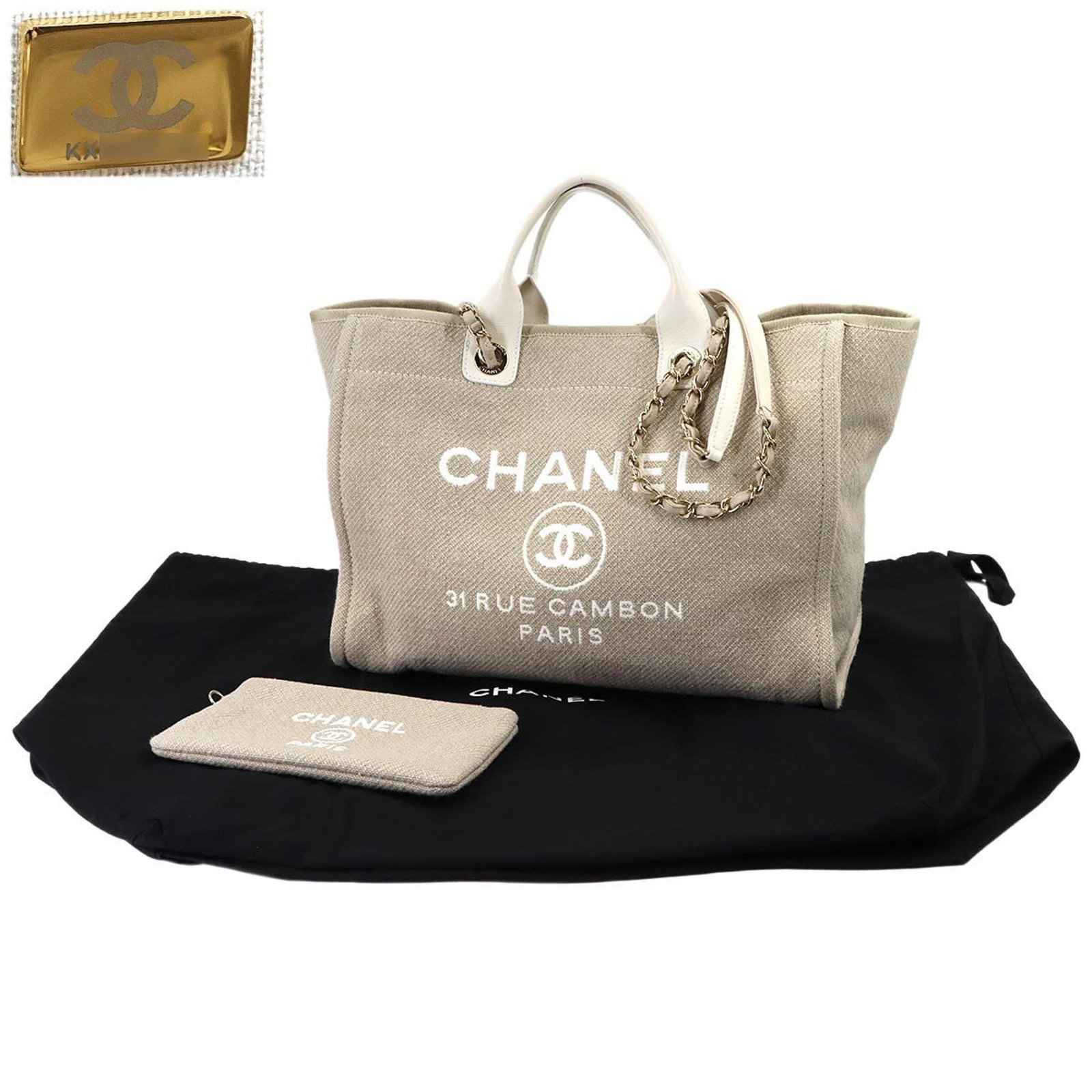 Chanel Tote Bag in Canvas and Leather: Chanel Tote Bag in Canvas and Leather Experience the timeless elegance of Chanel with this stunning beige and white canvas and leather tote bag, boasting a classic design that exudes sophistication an