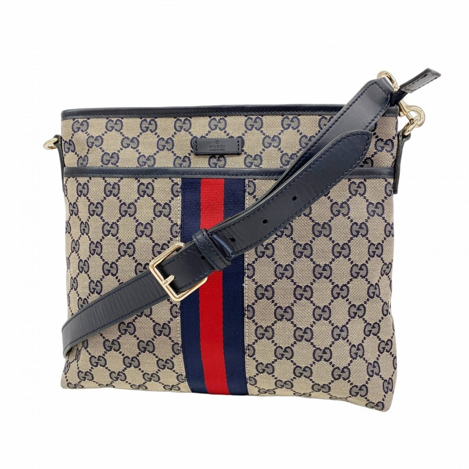 Gucci Canvas Shoulder Bag: Gucci Canvas Shoulder Bag A pre-owned Gucci canvas shoulder bag in navy, boasting a timeless design with champagne gold hardware that adds a touch of luxury to any outfit. With its spacious interior a