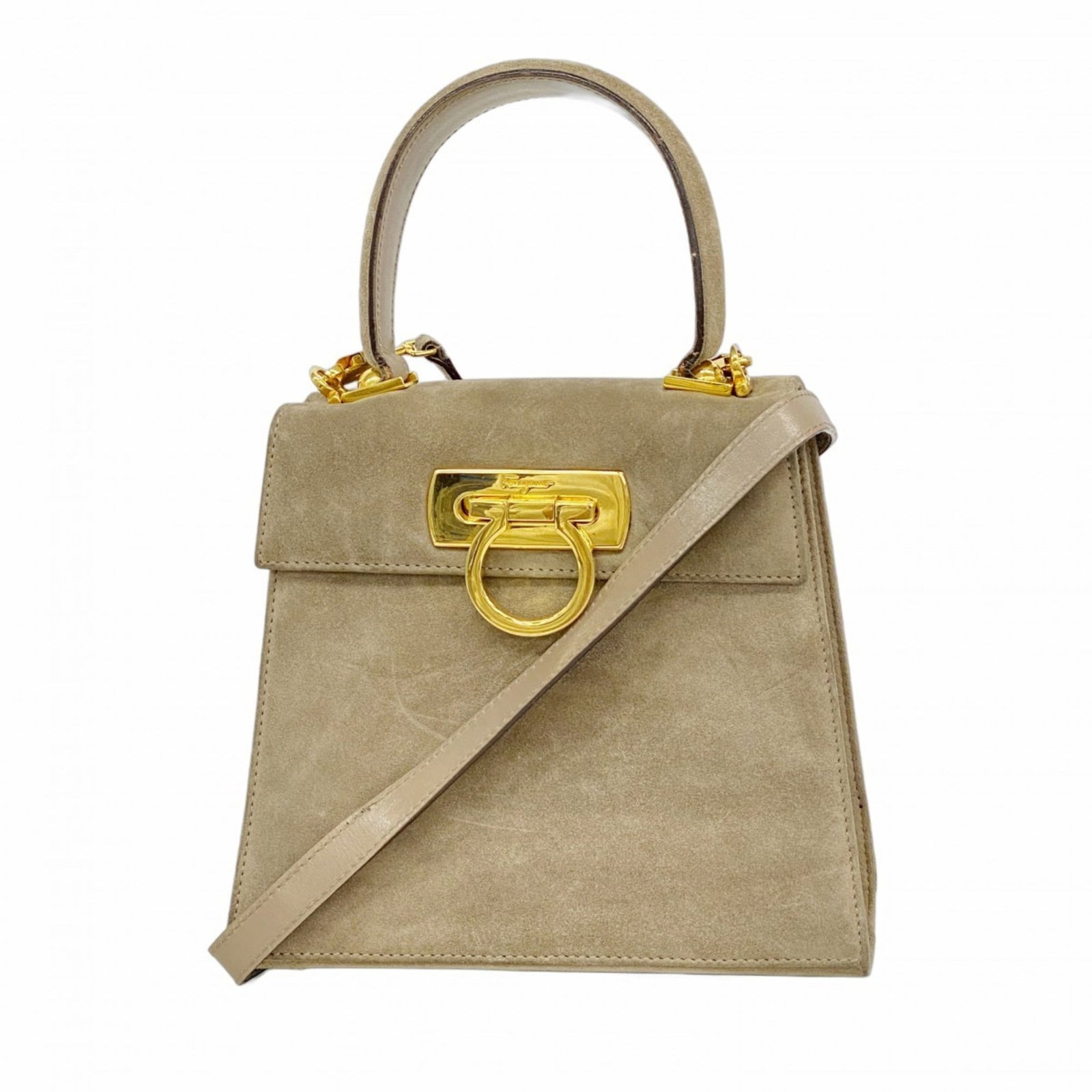 Suede Salvatore Ferragamo Handbag: Suede Salvatore Ferragamo Handbag Experience the timeless elegance of Salvatore Ferragamo's iconic handbag, crafted from luxurious suede and adorned with gold hardware. With its classic design and sop