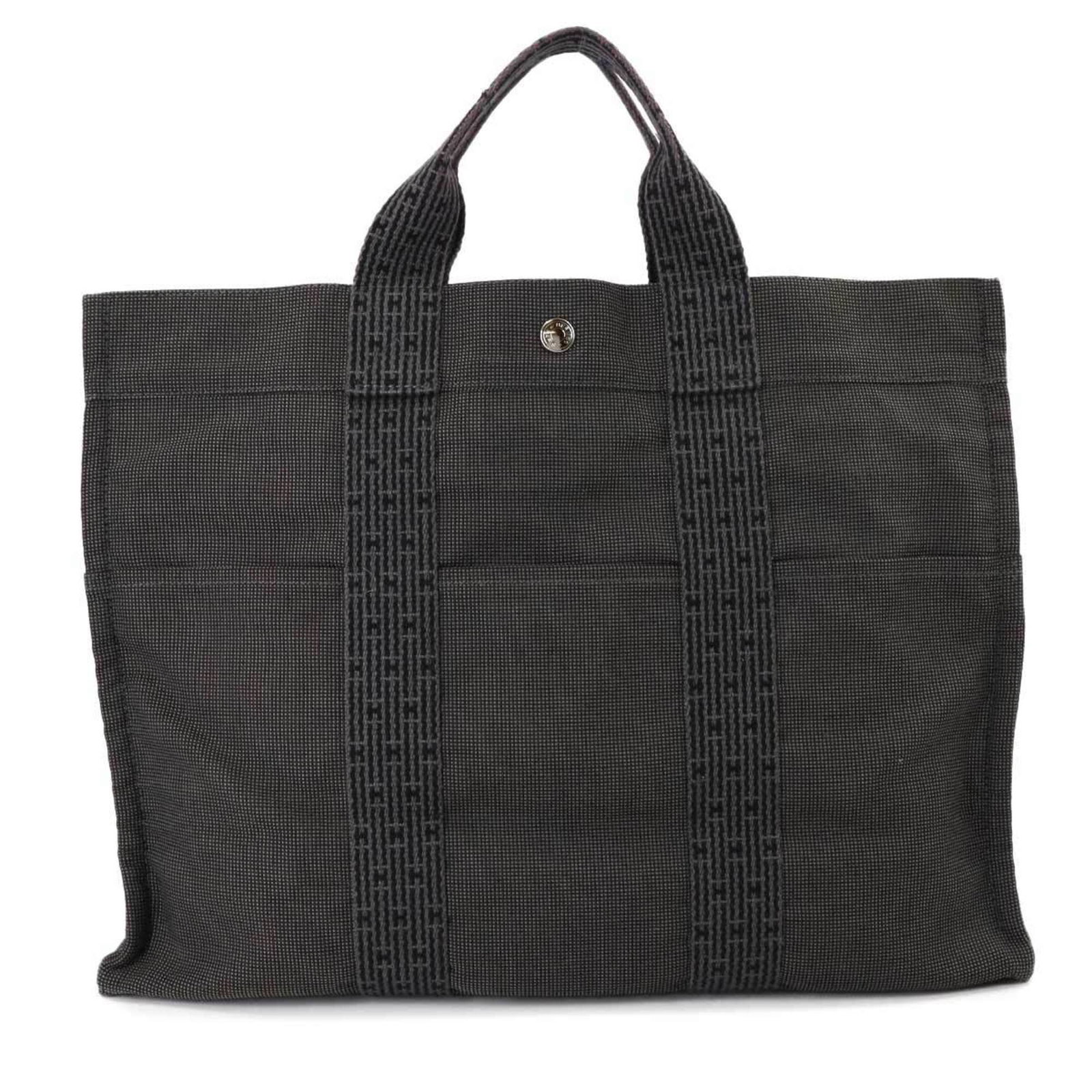 Hermes Canvas Tote Bag: Hermes Canvas Tote Bag Experience the timeless elegance of Herm?s with this stunning canvas tote bag, boasting a sleek gray hue and classic design that exudes sophistication. Measuring 31cm x 42cm x 1