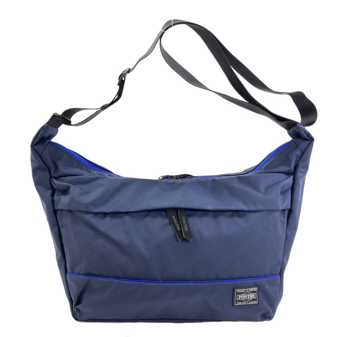 Nylon Porter Shoulder Bag: Nylon Porter Shoulder Bag A sturdy and stylish shoulder bag from Japan, crafted with high-quality nylon that can withstand daily wear and tear. The navy exterior exudes a sleek, professional look perf