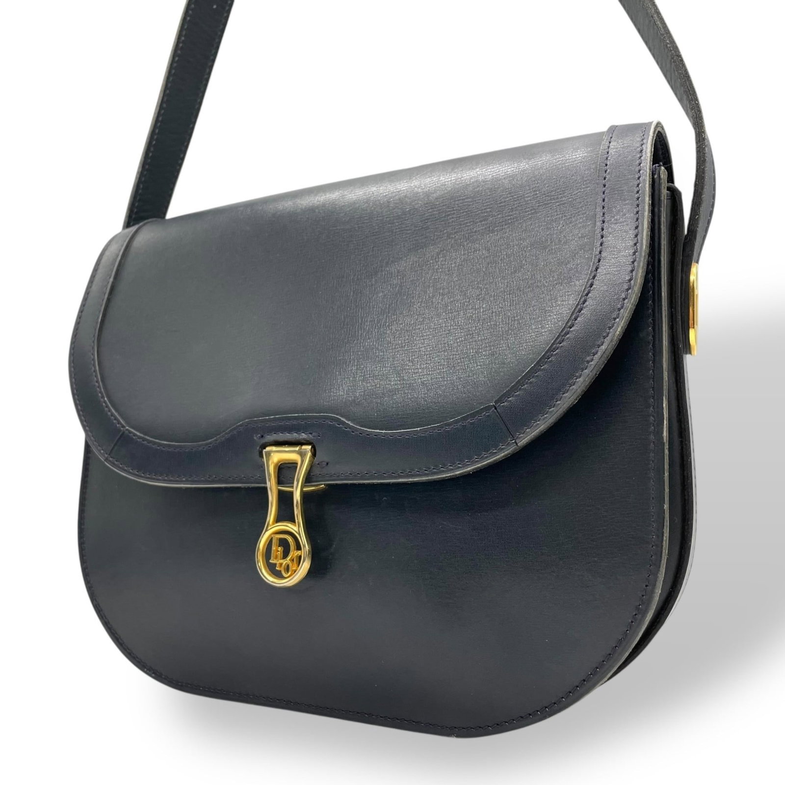 Christian Dior Shoulder Bag in Leather: Christian Dior Shoulder Bag in Leather A timeless and sophisticated shoulder bag, this classic Christian Dior design boasts rich navy leather and clean lines, perfect for adding a touch of elegance to