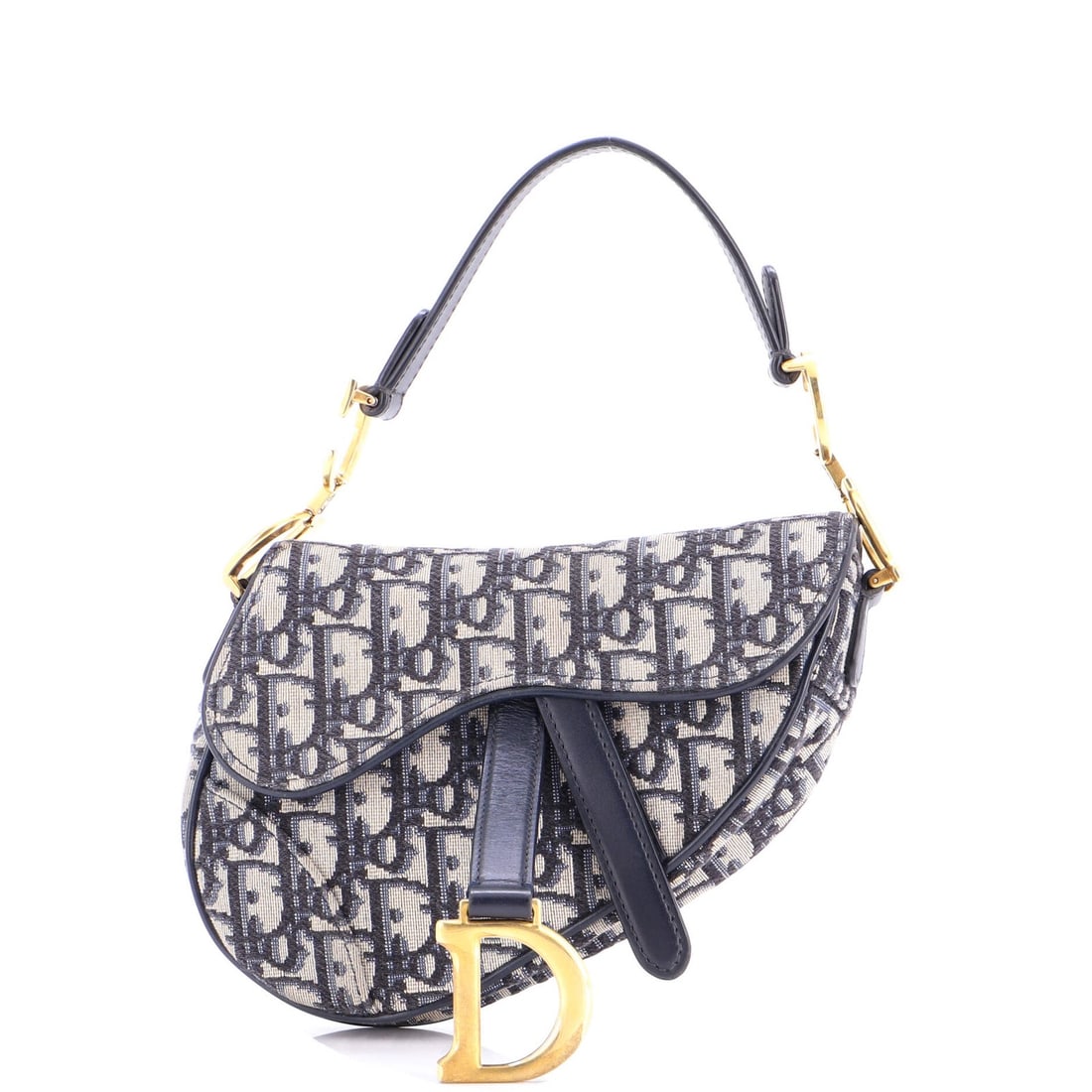 Christian Dior Mini Saddle Handbag in Oblique Canvas: Christian Dior Mini Saddle Handbag in Oblique Canvas The Christian Dior Mini Saddle Handbag in Oblique Canvas is a timeless and elegant accessory that exudes sophistication. With its classic saddle sh