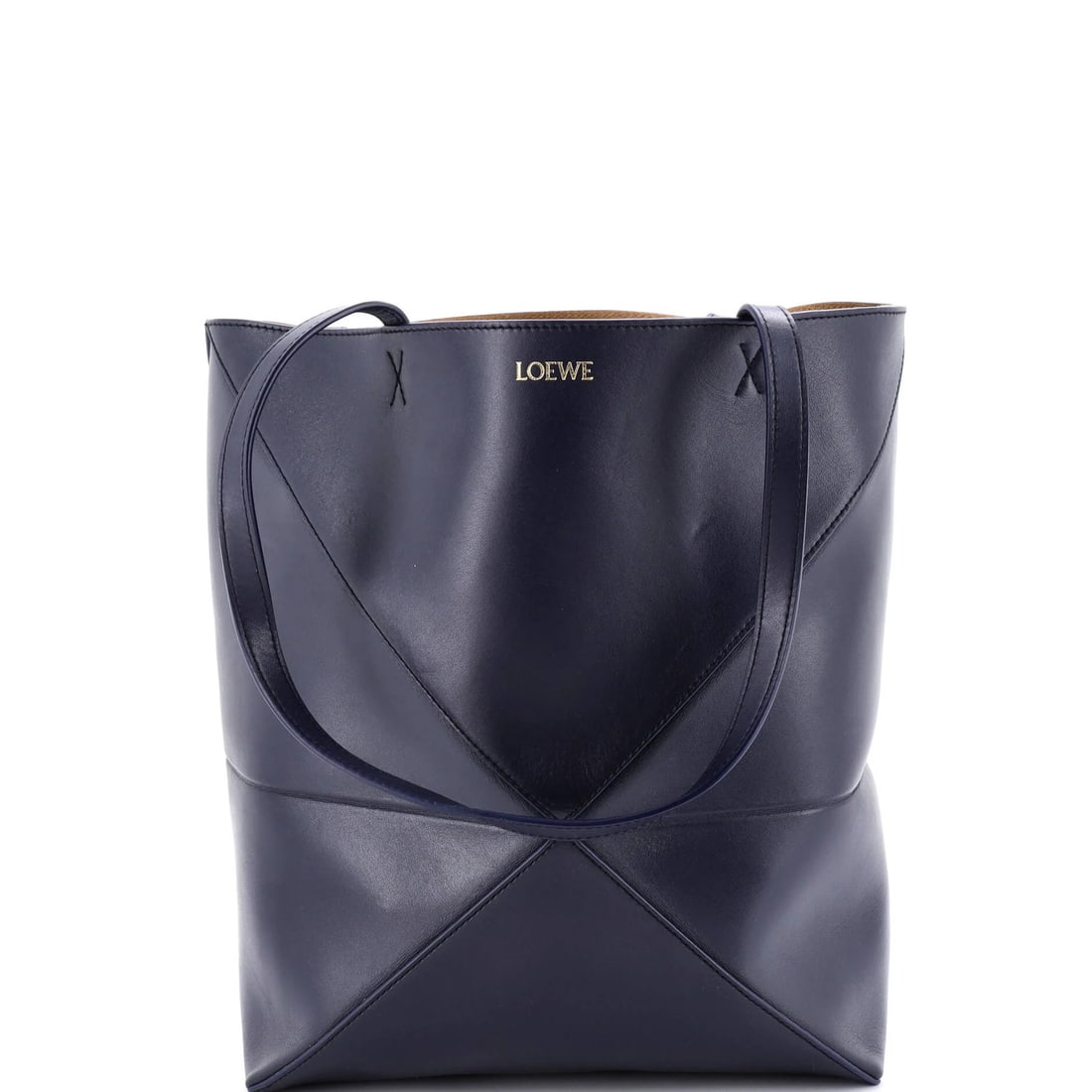 Loewe Puzzle Fold Tote in Medium Leather: Loewe Puzzle Fold Tote in Medium Leather The Loewe Puzzle Fold Tote is a timeless classic with its signature puzzle fold design, crafted from rich medium leather that develops a beautiful patina over