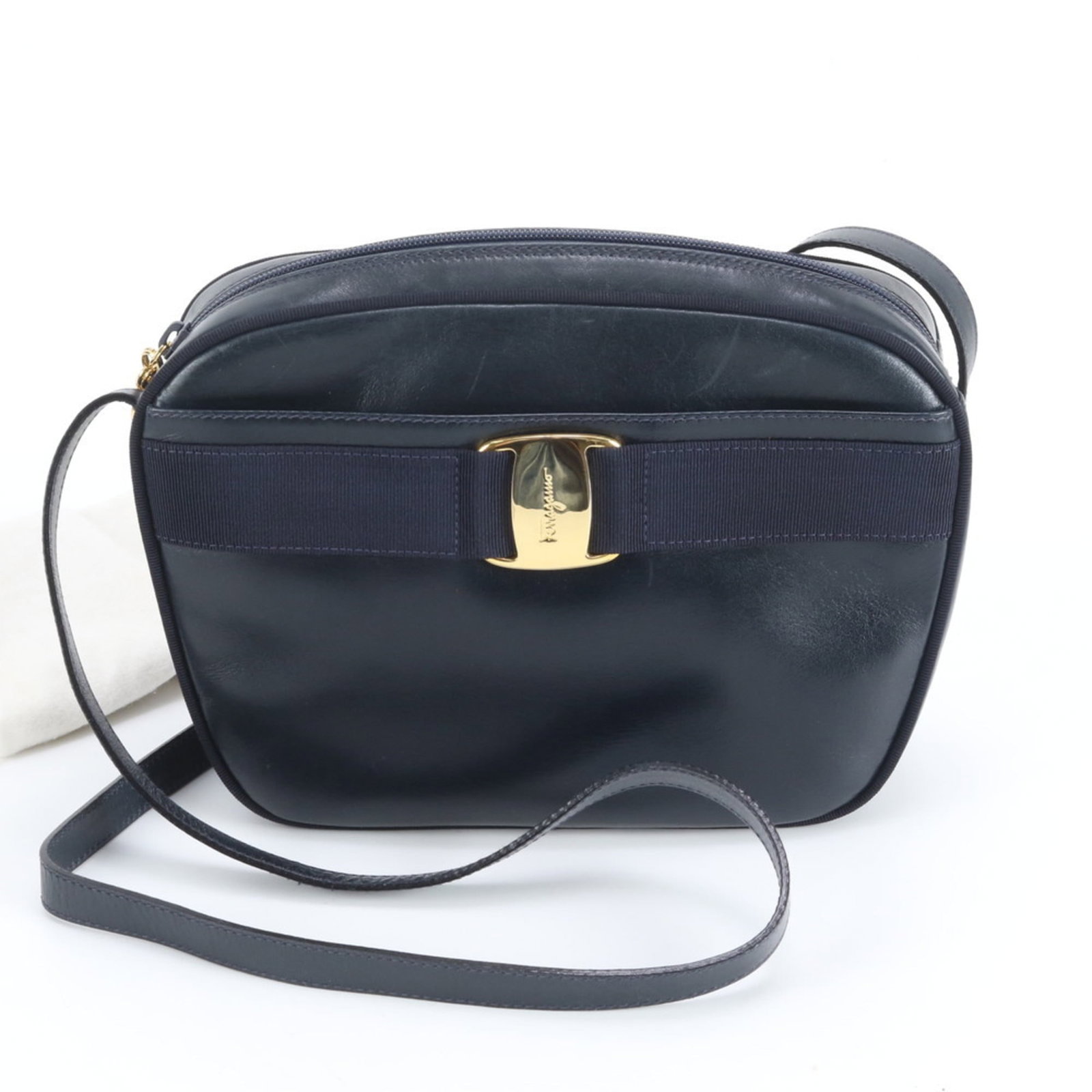 Salvatore Ferragamo Leather Shoulder Bag: Salvatore Ferragamo Leather Shoulder Bag A timeless and sophisticated choice for any woman, this navy leather shoulder bag from Salvatore Ferragamo boasts classic design with clean lines and elegant d