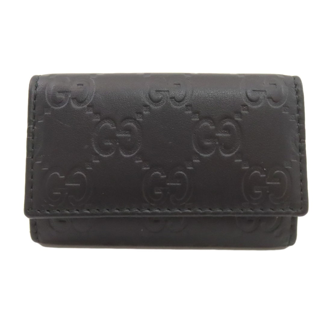 Gucci GG Signature Guccissima Key Holder in Leather: Gucci GG Signature Guccissima Key Holder in Leather Elevate your daily essentials with the iconic Gucci GG Signature Key Holder in Leather. Crafted from high-quality black leather, this sleek key hold