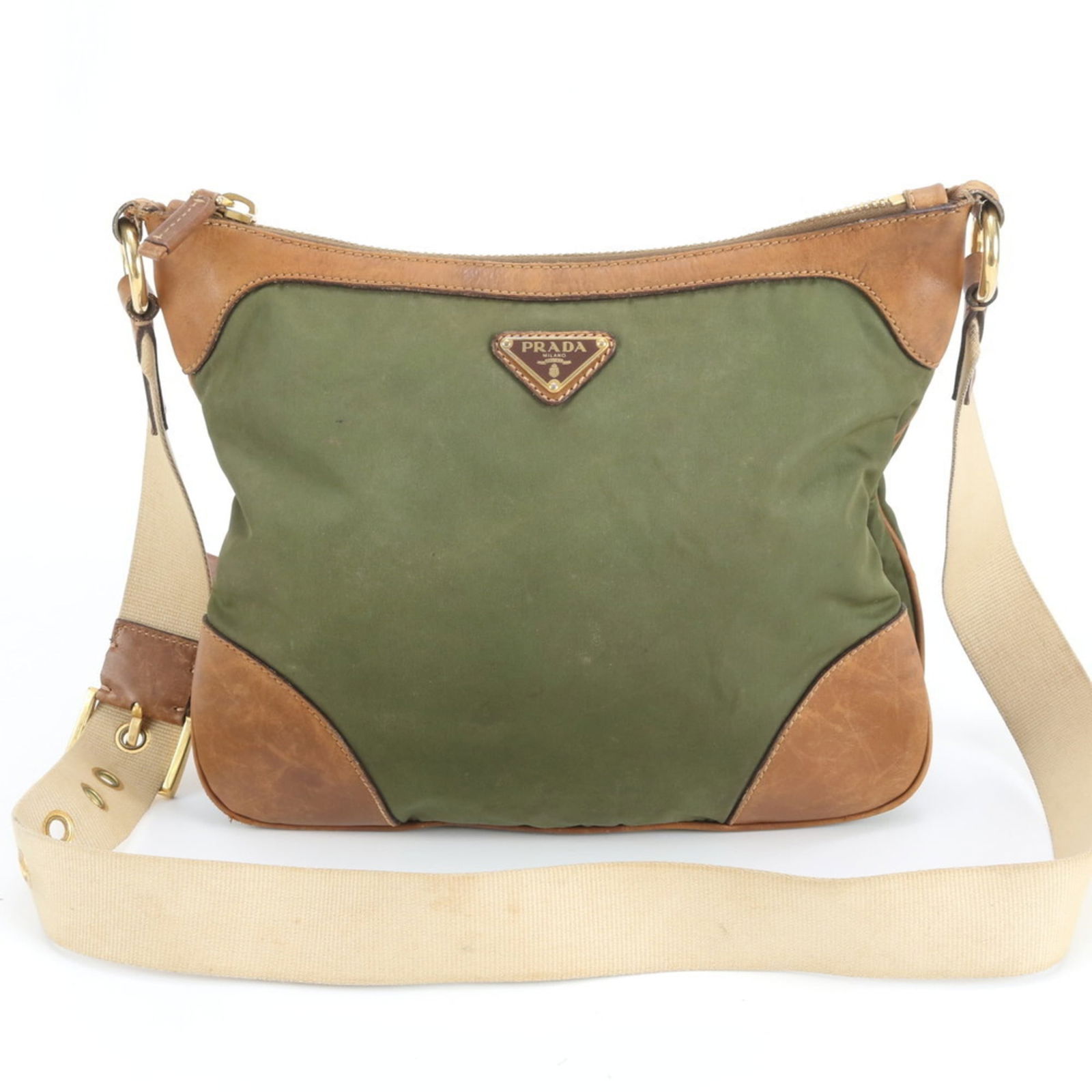 Prada Nylon and Leather Shoulder Bag: Prada Nylon and Leather Shoulder Bag A stylish and versatile Prada shoulder bag, crafted from durable nylon and supple leather, boasts a timeless design that's perfect for everyday wear. The classic b