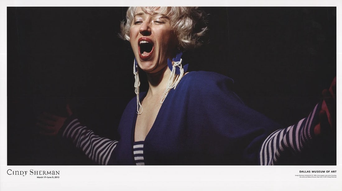 Cindy Sherman, Untitled #119, 2013, 13.5" x 23.75", Blue and Black Photography Poster: Cindy Sherman, Untitled #119, 2013, 13.5" x 23.75", Blue and Black Photography Poster Cindy Sherman's Untitled #119 (2013) is a striking example of the artist's signature style, featuring a bold and e