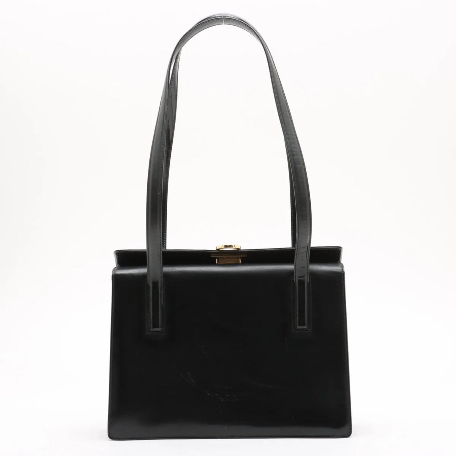 Salvatore Ferragamo Leather Tote Bag: Salvatore Ferragamo Leather Tote Bag A timeless and sophisticated shoulder tote from Salvatore Ferragamo, crafted from rich black leather that develops a beautiful patina with age. With its classic de