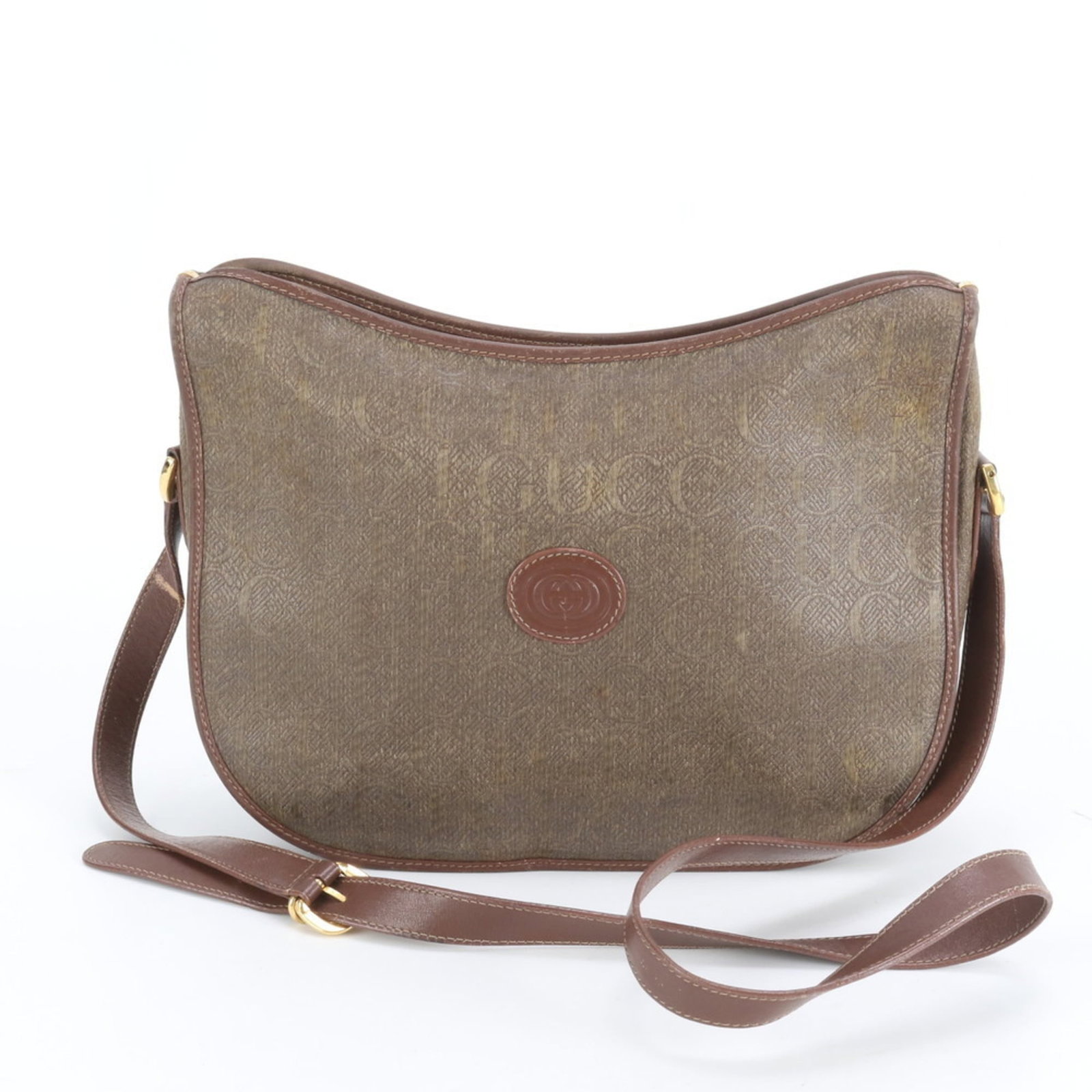Gucci shoulder bag in leather and coated canvas: Gucci shoulder bag in leather and coated canvas A classic Gucci shoulder bag in rich brown leather and coated canvas, perfect for adding an air of sophistication to any outfit. With its spacious inter
