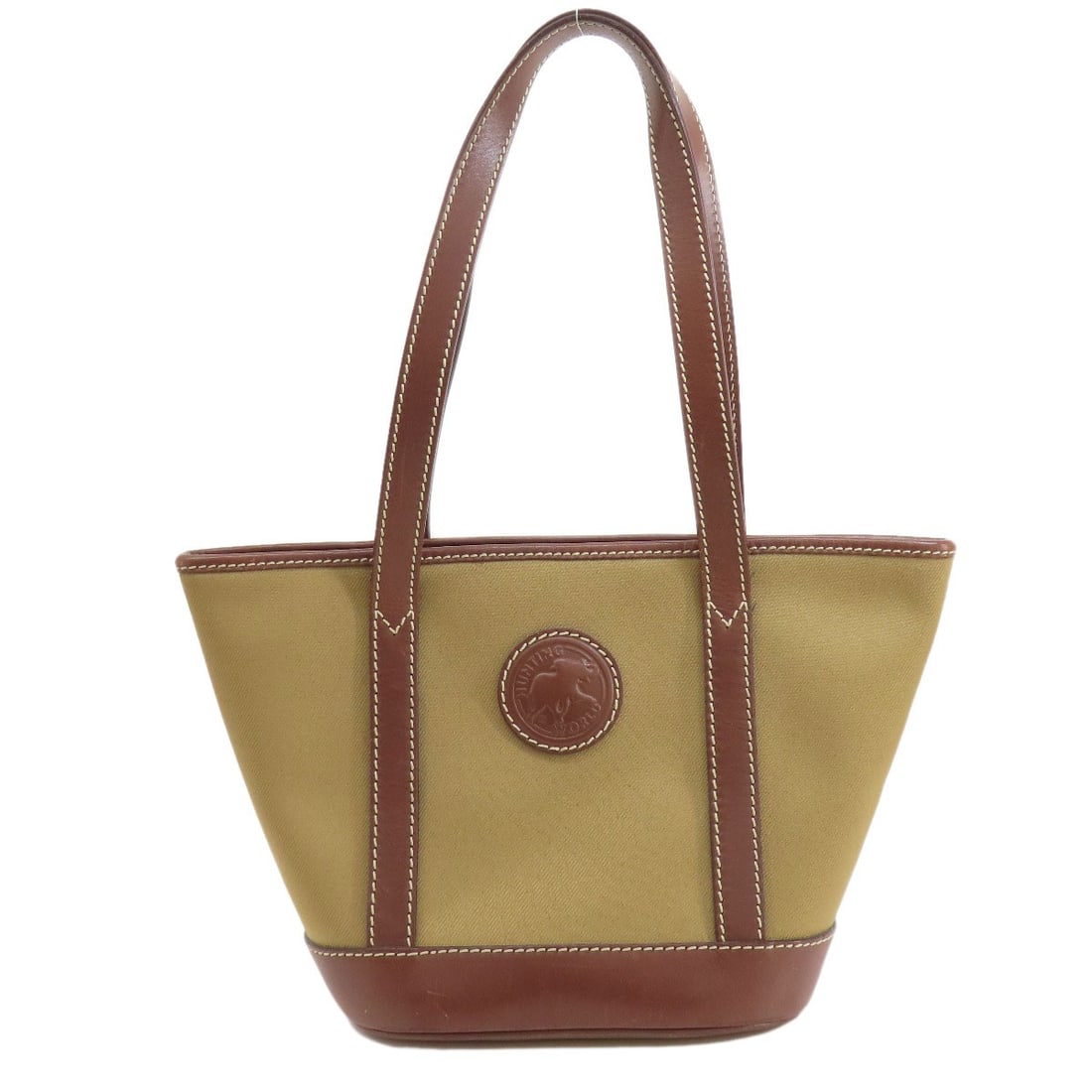 Canvas Hunting World Logo Tote Bag: Canvas Hunting World Logo Tote Bag Take your outdoor adventures in style with this rugged canvas tote bag, featuring the iconic Hunting World logo. Made from durable khaki canvas and boasting a vibran