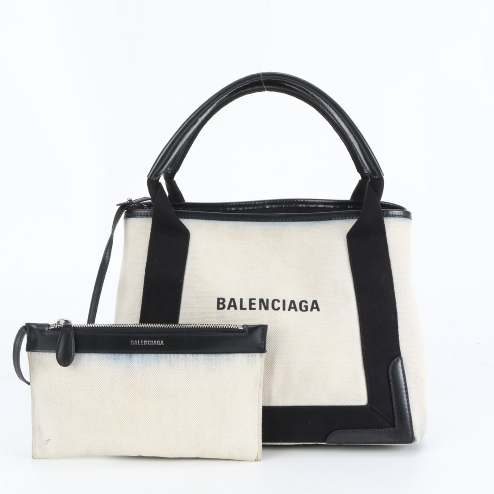 Balenciaga Tote Bag in Leather and Canvas: Balenciaga Tote Bag in Leather and Canvas A pre-owned Balenciaga tote bag in rich beige and black, crafted from high-quality leather and canvas. With its classic design and spacious interior, this ver