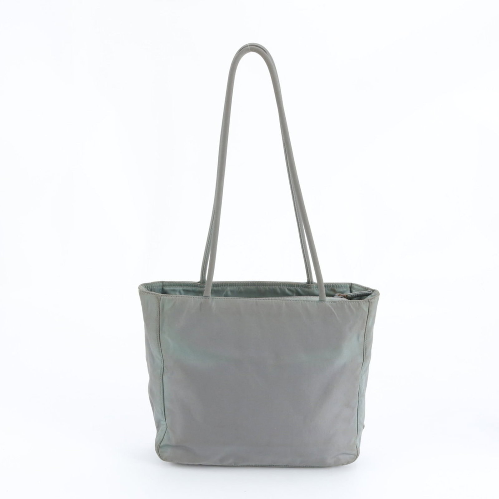Prada Nylon Tote Bag: Prada Nylon Tote Bag A timeless and versatile Prada tote, crafted from durable nylon, boasts a sleek gray and green color combination that exudes effortless chic. With its spacious interior and adjust