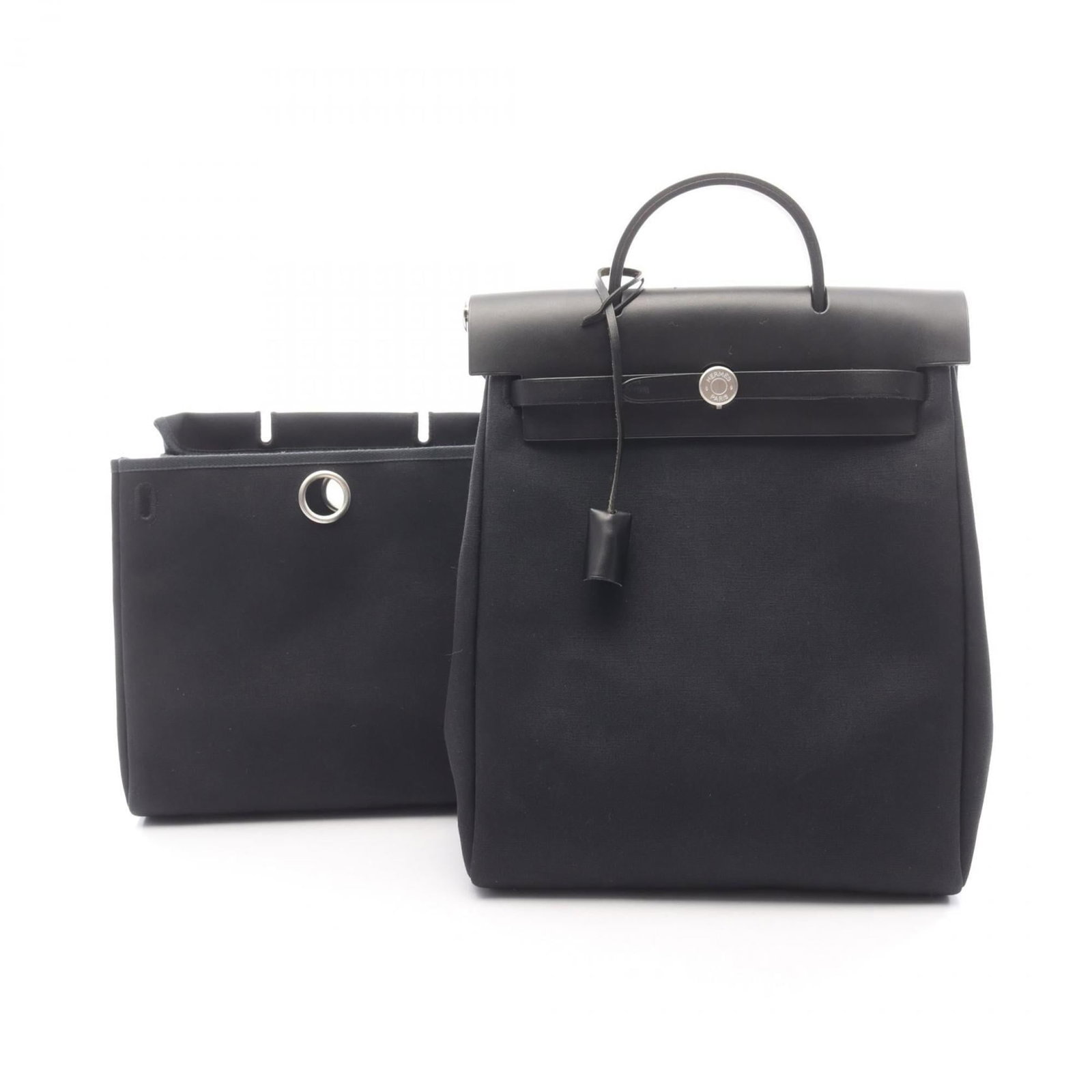 Hermes Canvas and Leather Toile Officier Handbag Backpack: Hermes Canvas and Leather Toile Officier Handbag Backpack The iconic Hermes Toile Officier backpack is a timeless and sophisticated accessory for the modern woman. Crafted from luxurious canvas, leath