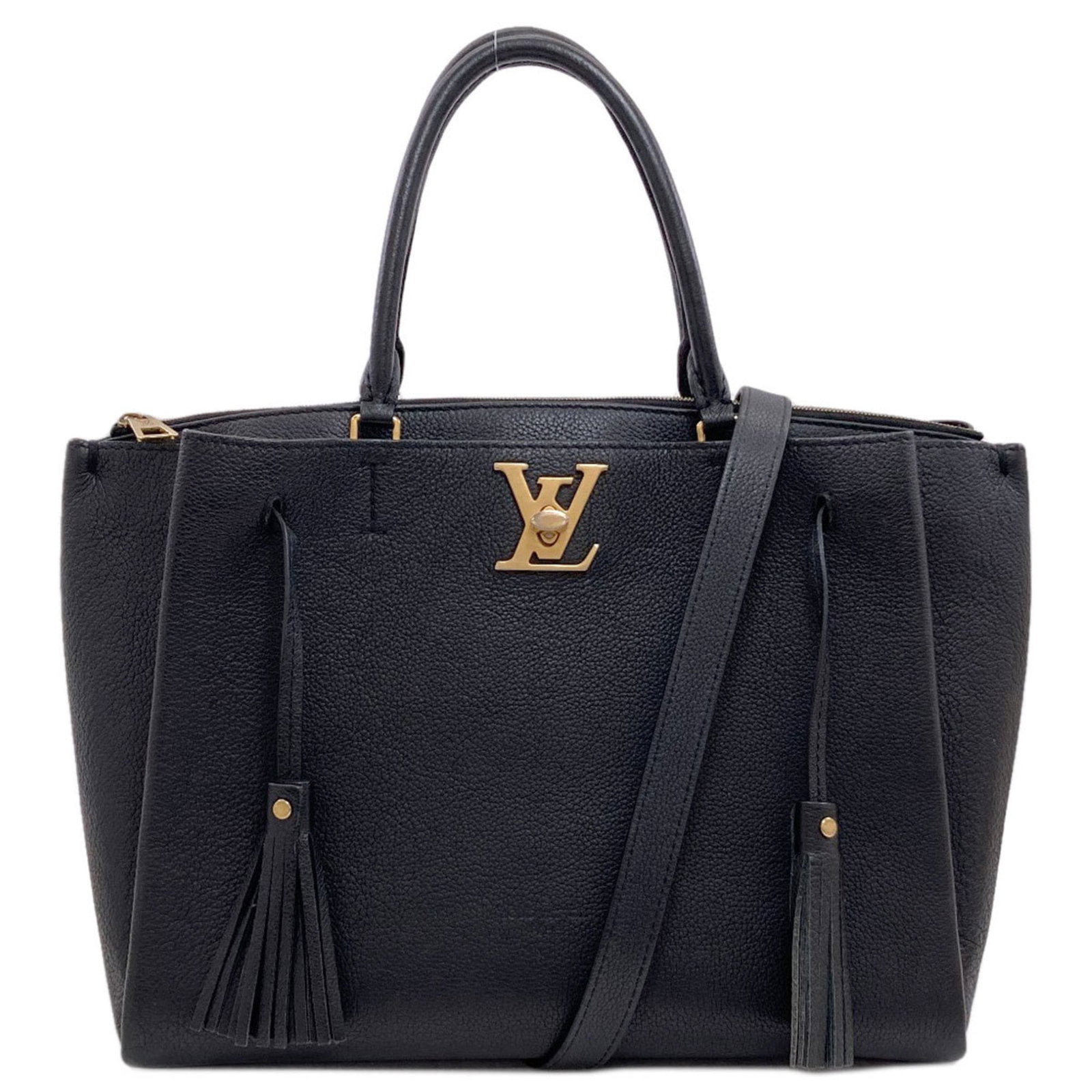 Louis Vuitton Leather Handbag: Louis Vuitton Leather Handbag A sleek and sophisticated black leather handbag from the iconic Louis Vuitton brand, boasting a sturdy lock on the outer pocket for added security. With its spacious inte