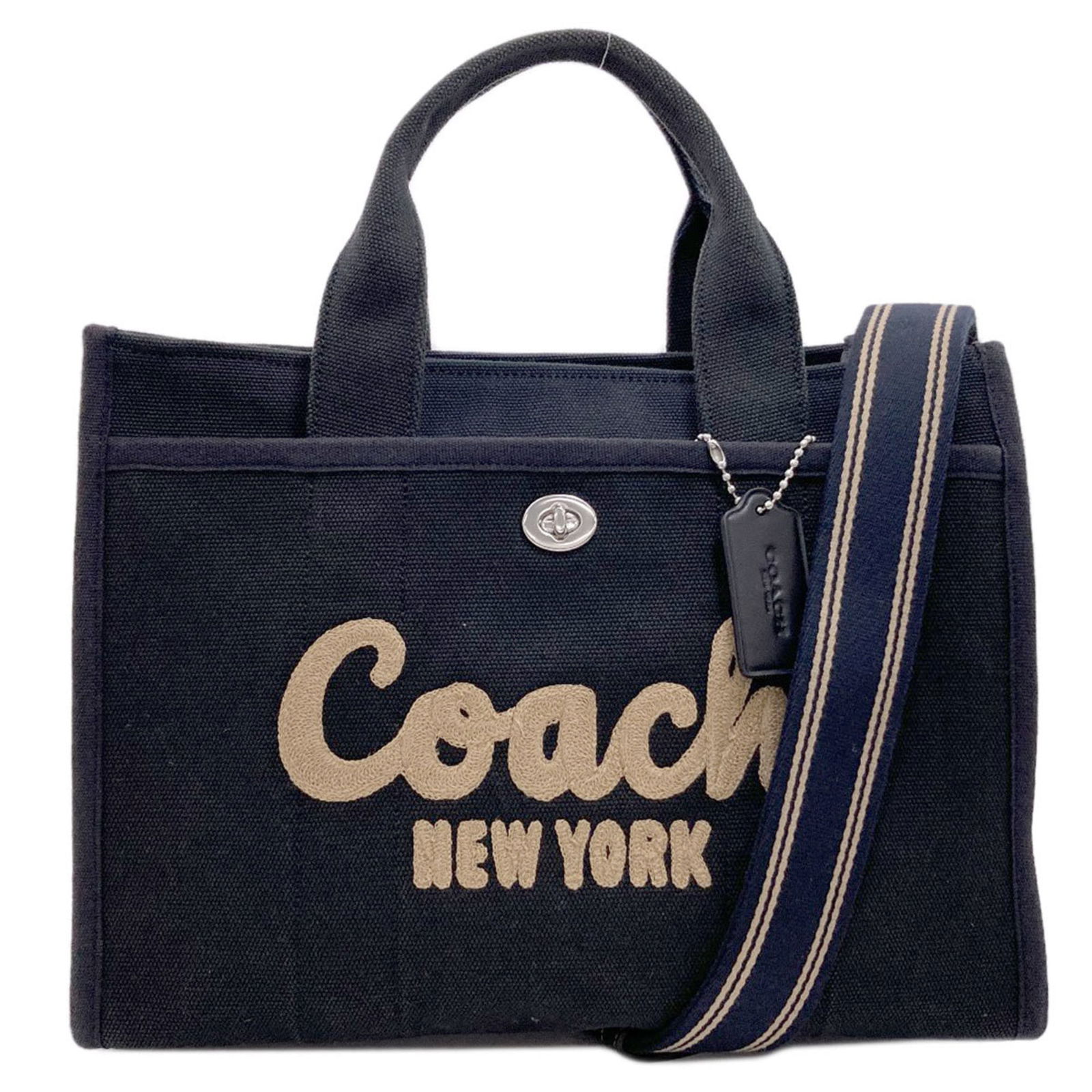 Canvas Coach Handbag: Canvas Coach Handbag A sleek and sophisticated black canvas Coach handbag, perfect for everyday use, boasts a sturdy zipper closure, turn lock pocket, and spacious outer compartment. With its classic
