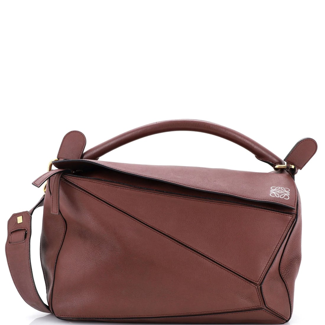 Loewe Puzzle Bag in Large Leather: Loewe Puzzle Bag in Large Leather A timeless and sophisticated Loewe Puzzle Bag in rich, dark brown leather awaits. With its classic design and spacious interior, this large satchel is perfect for eve