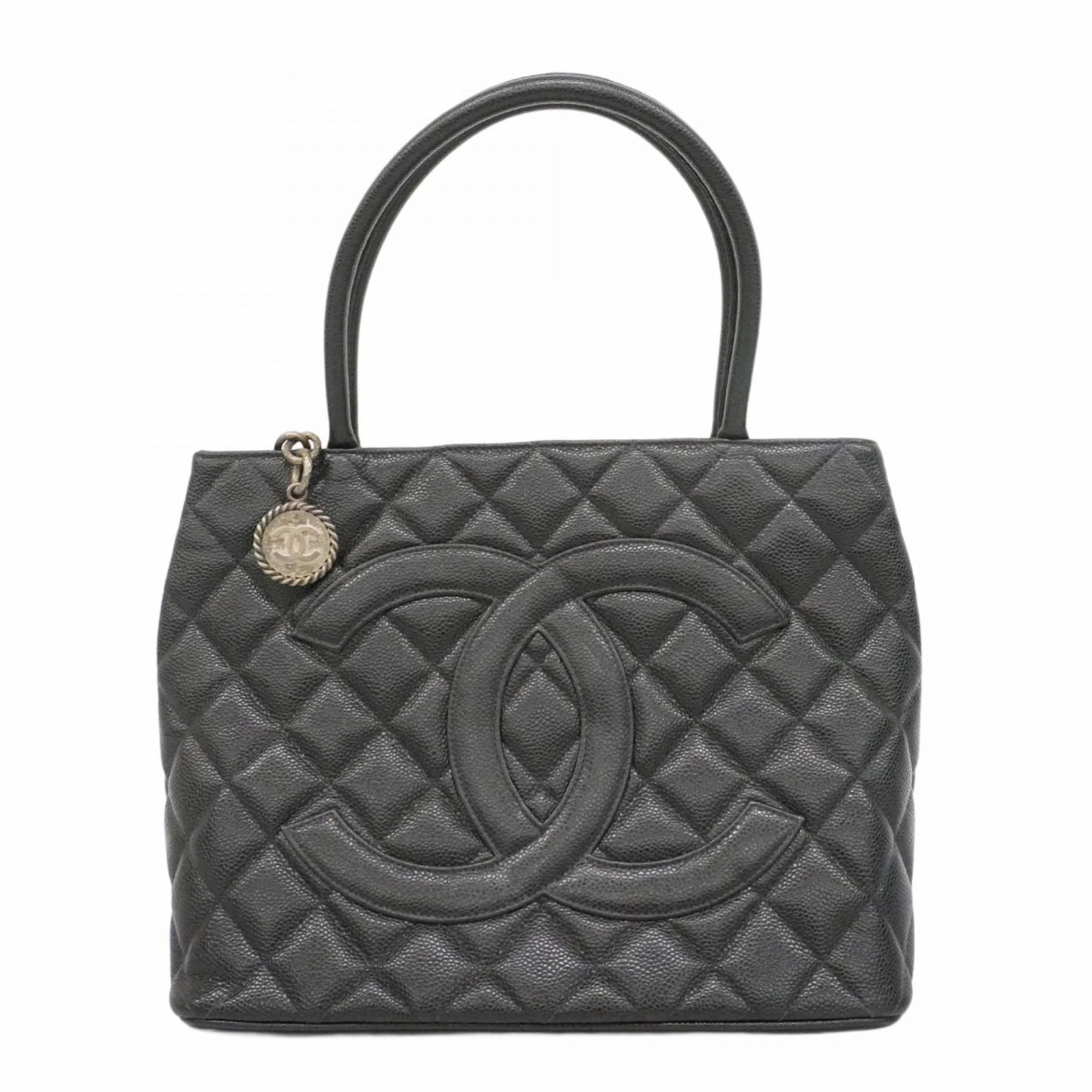 Calfskin Grained Chanel Tote Bag: Calfskin Grained Chanel Tote Bag A timeless Chanel classic, this black grained calfskin tote bag exudes elegance with its sleek design and silver hardware. With its spacious interior and sturdy constr