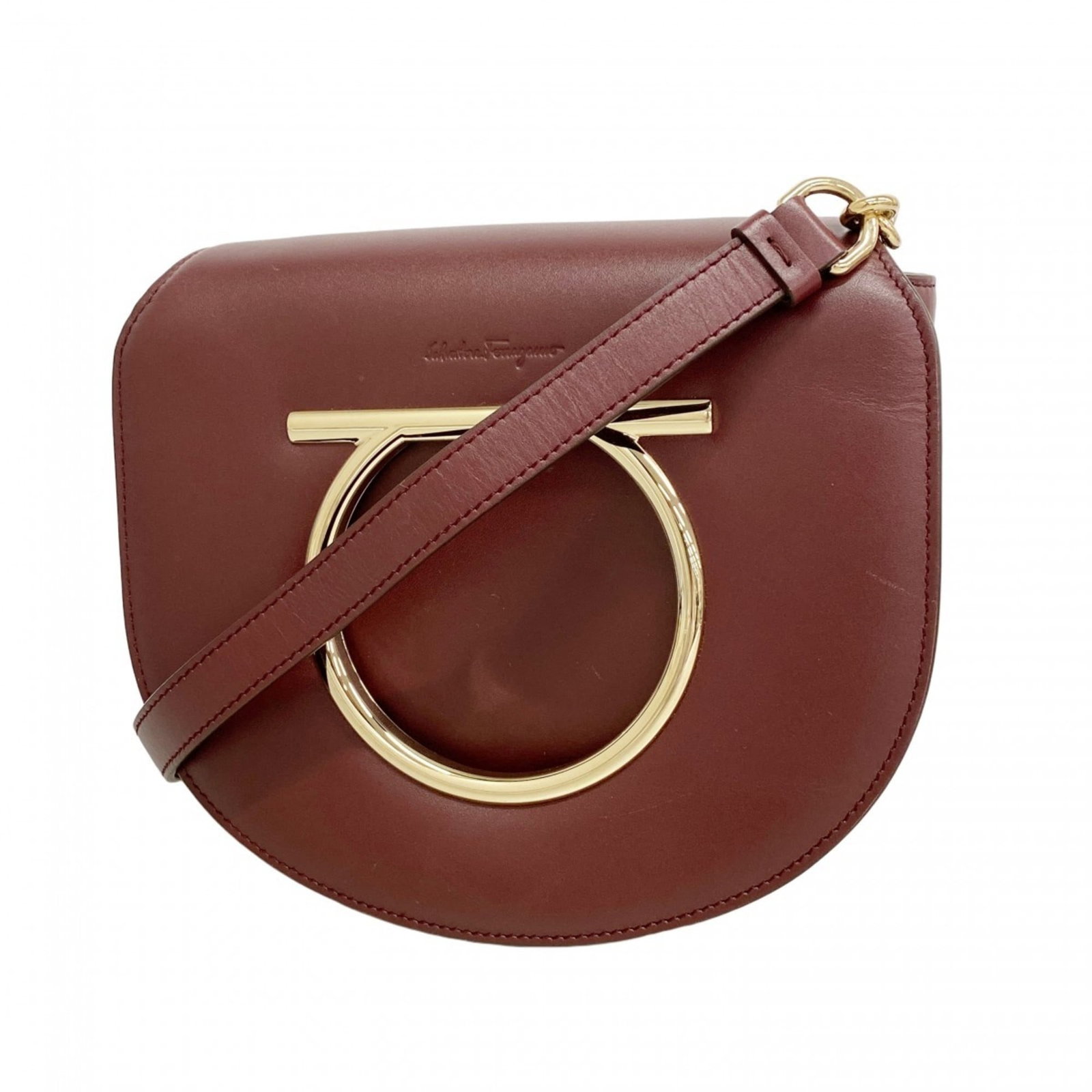 Salvatore Ferragamo Leather Shoulder Bag: Salvatore Ferragamo Leather Shoulder Bag A stunning Bordeaux leather shoulder bag from Salvatore Ferragamo, boasting classic elegance with champagne gold hardware accents that add a touch of
