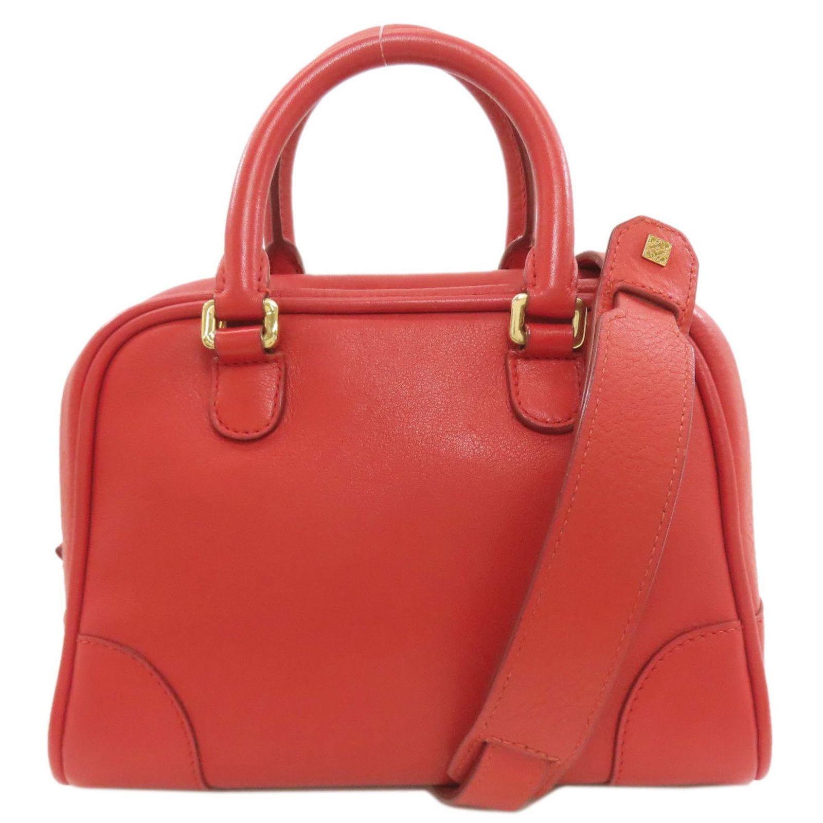 Loewe Leather Handbag: Loewe Leather Handbag A vibrant red Loewe leather handbag, exuding timeless elegance and sophistication. With its classic design and premium materials, this pre-owned beauty boasts a rich patina that