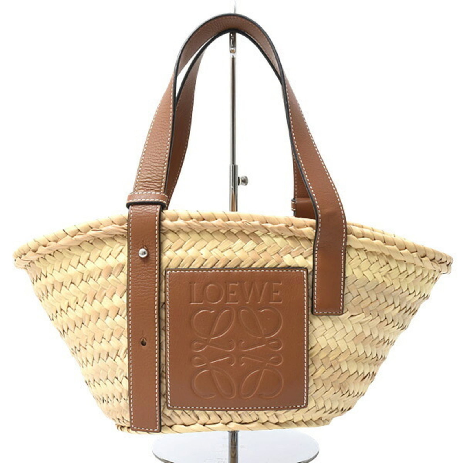 Handbag Loewe: Handbag Loewe A pre-owned Loewe handbag in rich, warm brown leather adds a touch of sophisticated elegance to any outfit. With its classic design and premium materials, this timeless piece is sure to