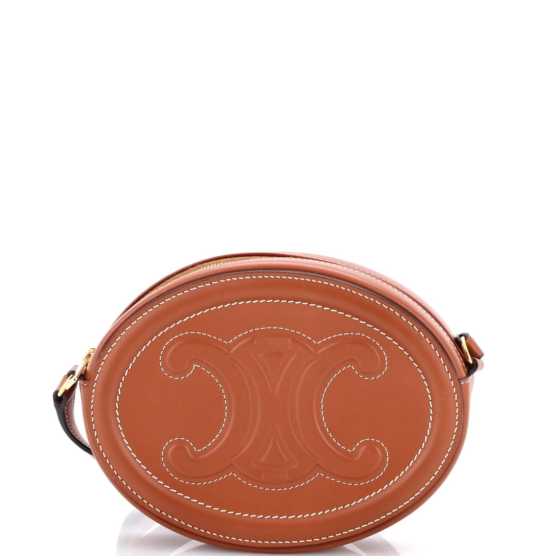 Celine Triomphe Oval Mini Crossbody Bag in Leather: Celine Triomphe Oval Mini Crossbody Bag in Leather Elevate your everyday style with the Celine Triomphe Oval Mini Crossbody Bag in rich, luxurious leather. This chic mini bag boasts a timeless oval sh