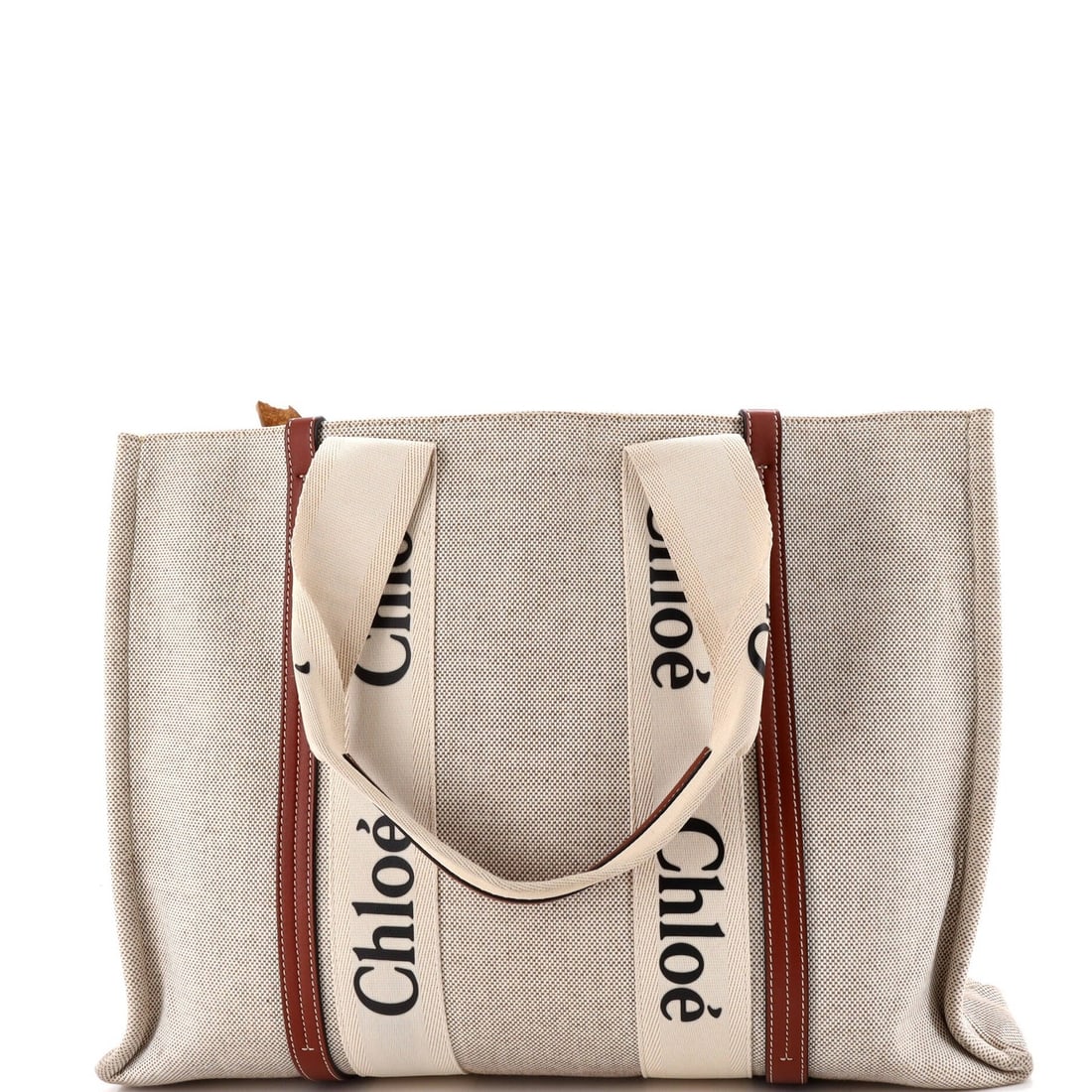 Large Chloe Woody Tote Canvas with Leather: Large Chloe Woody Tote Canvas with Leather Experience the timeless elegance of the Chloe Woody Tote, a classic design that exudes sophistication and versatility. With its sturdy canvas exterior,