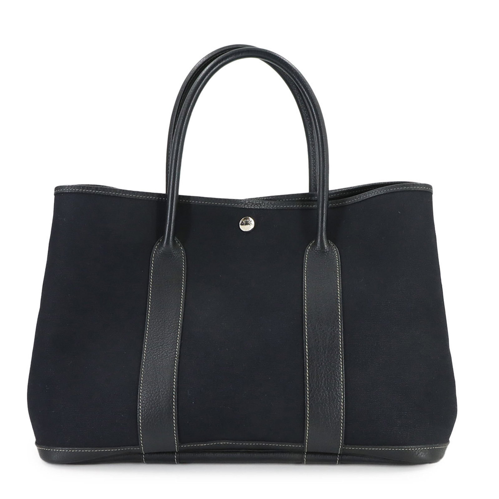 Hermes Toile Officier Leather Tote Bag: Hermes Toile Officier Leather Tote Bag Experience the timeless elegance of Herm?s with this stunning Toile Officier leather tote bag, boasting the iconic black color and classic design that has captiv