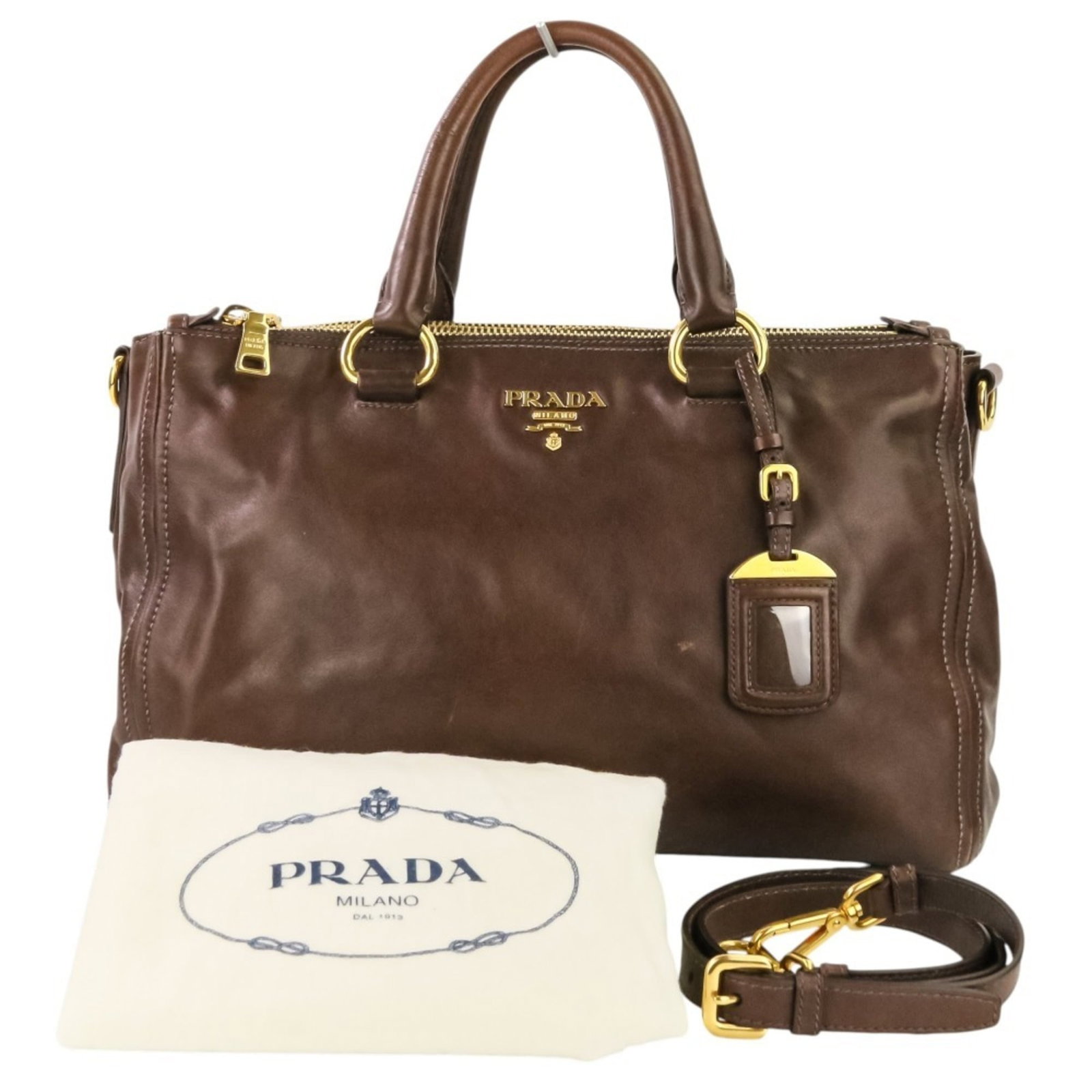 Prada Leather Handbag: Prada Leather Handbag A timeless Prada leather handbag in rich brown, boasting a classic design with clean lines and premium quality craftsmanship. With its sturdy 32cm handle and adjustable strap len