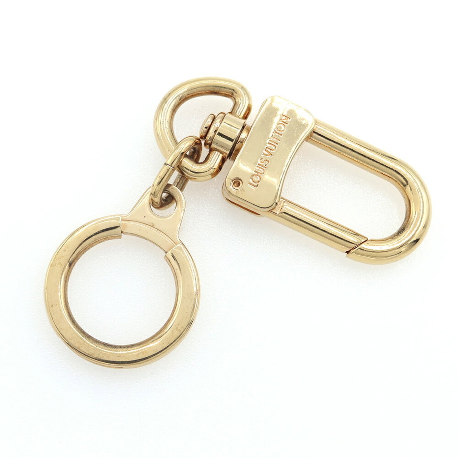 Keyring Louis Vuitton: Keyring Louis Vuitton A luxurious touch for your keys, this authentic Louis Vuitton keyring boasts a sleek gold finish and the iconic LV monogram pattern, adding a sophisticated touch to any outfit. W
