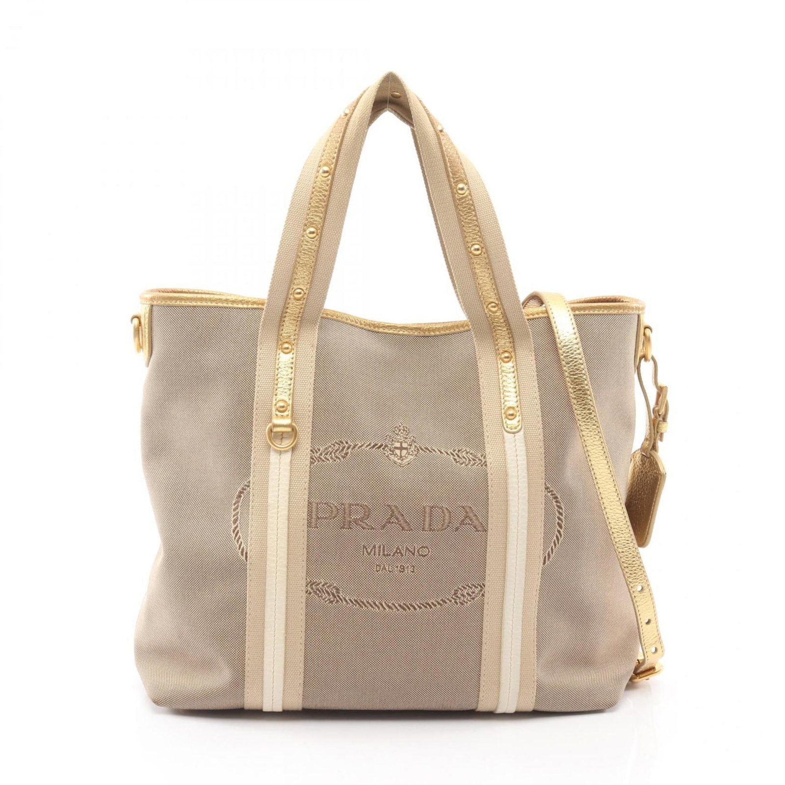 Prada Canvas and Leather Handbag: Prada Canvas and Leather Handbag A timeless Prada handbag, this beige canvas and leather tote boasts elegant gold hardware and a classic design that exudes sophistication. With its spacious interior a