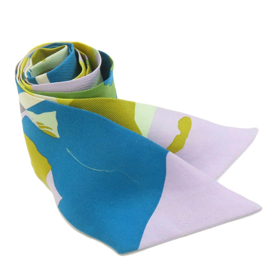 Hermes Twilly Scarf in Silk: Hermes Twilly Scarf in Silk Experience the timeless elegance of Herm?s with this stunning silk Twilly scarf, woven from a rich blend of green, purple, and blue hues that evoke the essence of French pa