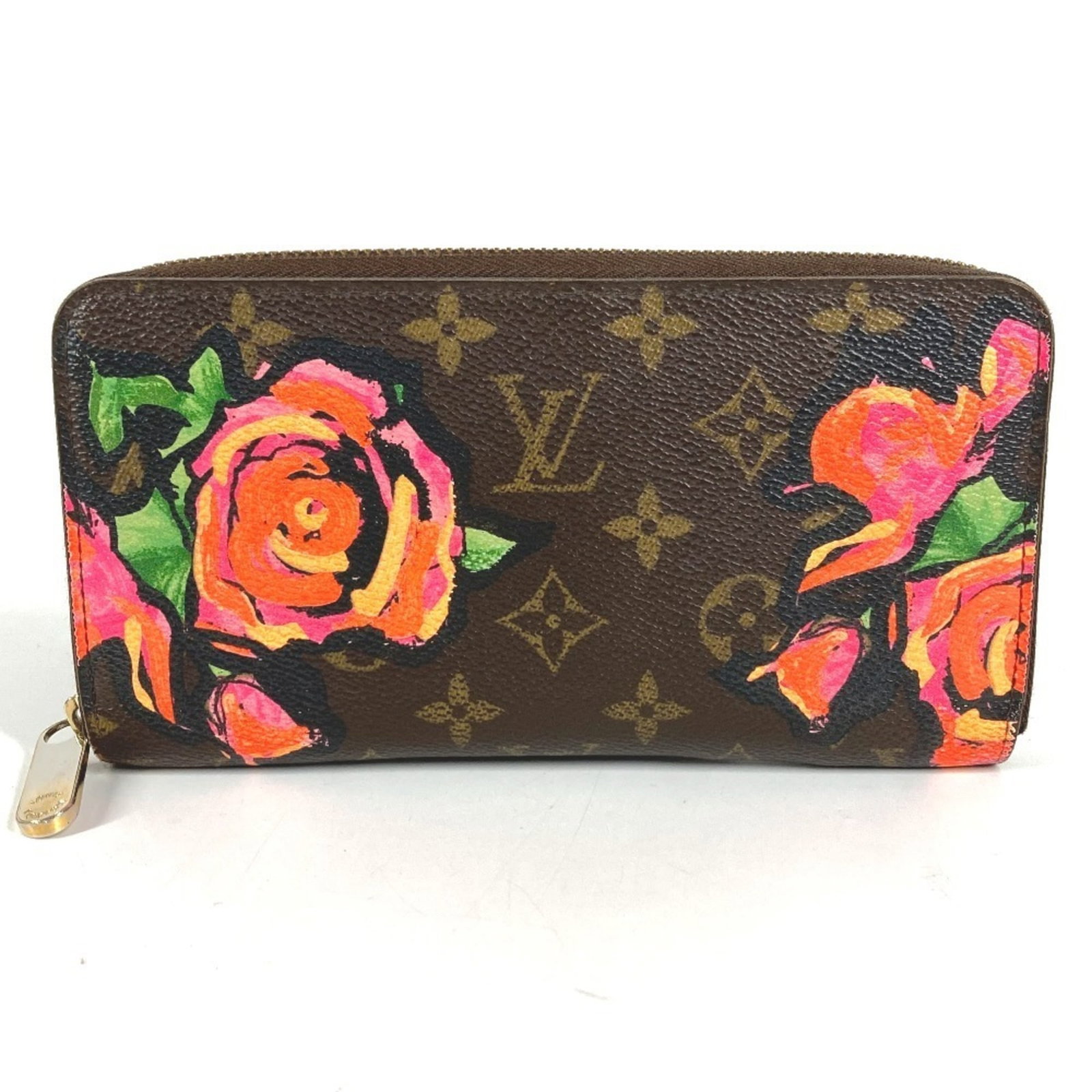 Louis Vuitton Bi-Fold Canvas Long Wallet: Louis Vuitton Bi-Fold Canvas Long Wallet A timeless piece from the iconic Louis Vuitton brand, this bi-fold canvas long wallet boasts classic monogram and rose patterns in rich brown hues. With its st