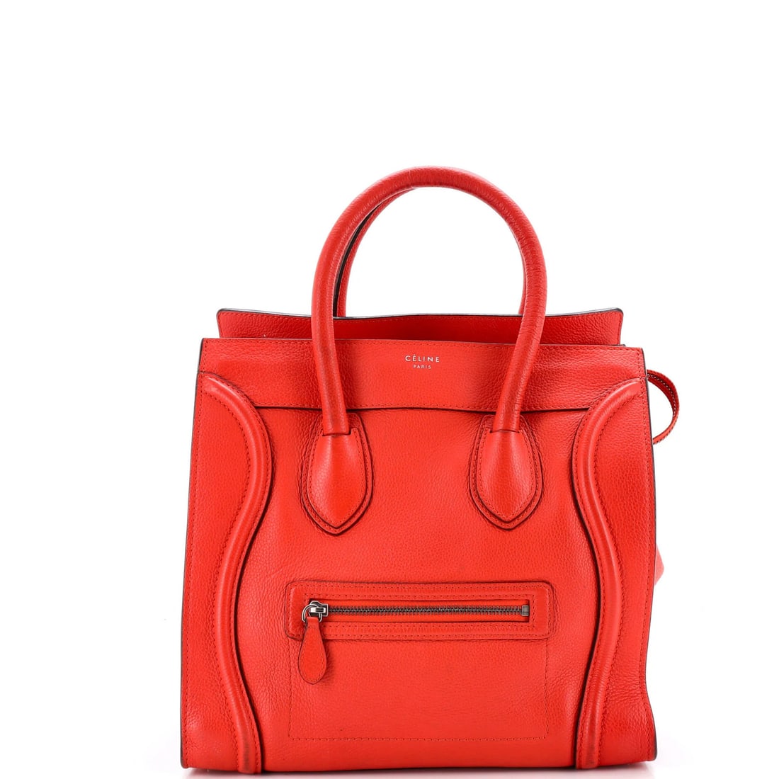 Celine Mini Luggage Bag in Grainy Leather: Celine Mini Luggage Bag in Grainy Leather A vibrant orange Celine mini luggage bag in grainy leather adds a pop of color to any travel routine. With its compact size and classic design, this stylish t