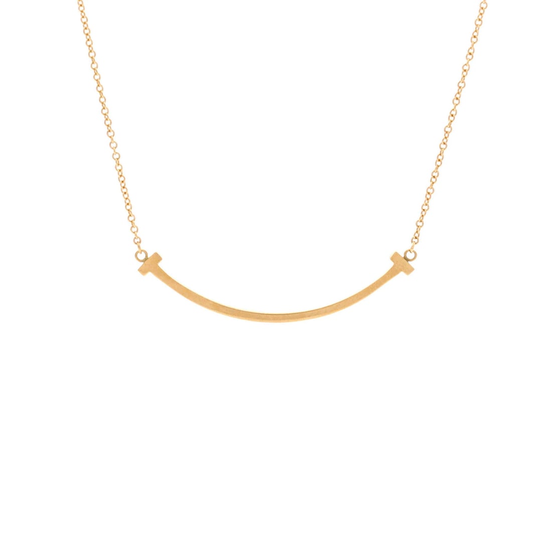 Tiffany & Co. T Smile Pendant in 18K Yellow Gold: Tiffany & Co. T Smile Pendant in 18K Yellow Gold Elevate your style with the iconic Tiffany & Co. T Smile Pendant, crafted in 18K yellow gold and boasting an understated elegance. This exquisite neckl