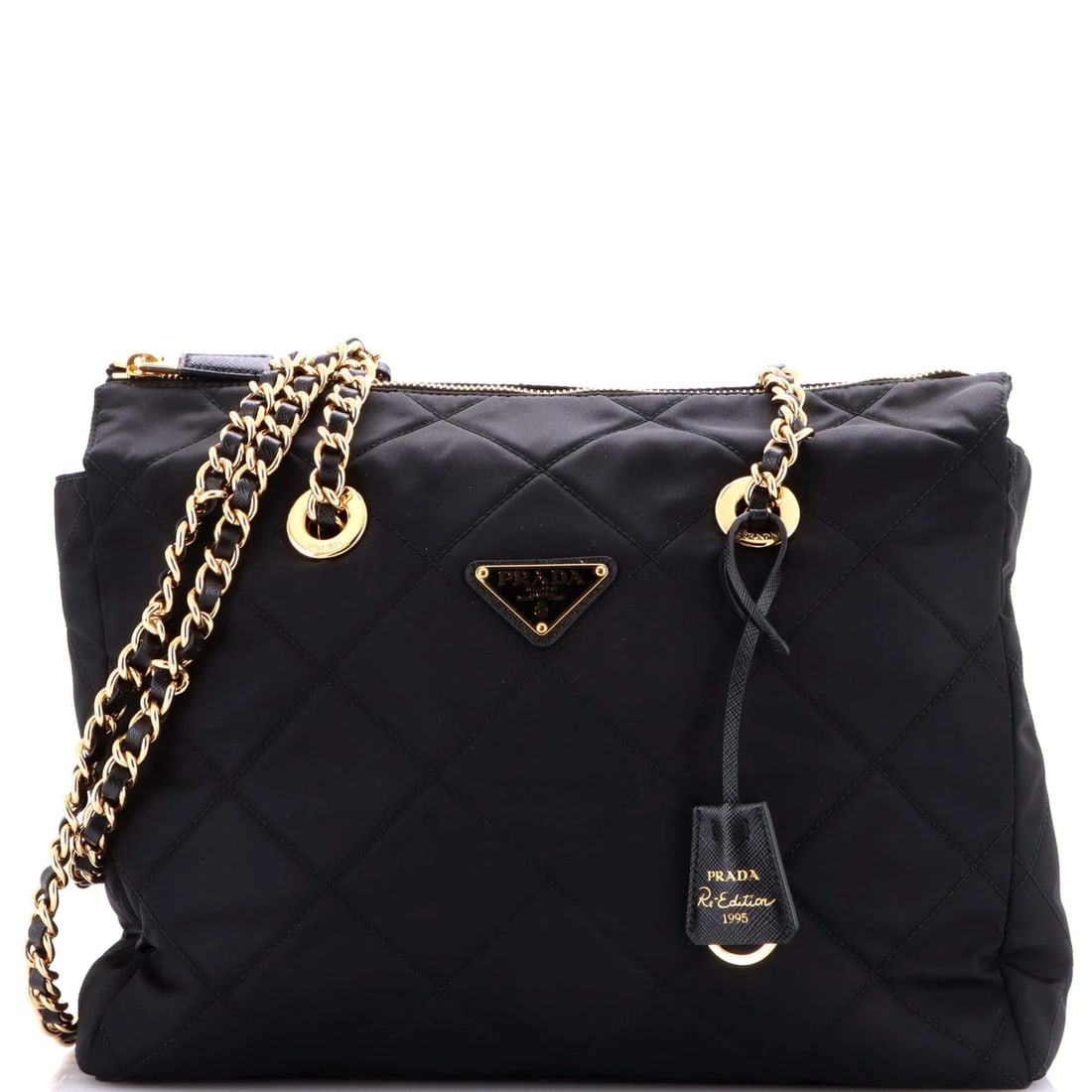 Quilted Nylon Medium Prada 1995 Chain Tote: Quilted Nylon Medium Prada 1995 Chain Tote A quintessential 90s style icon, the Prada 1995 Chain Tote exudes timeless sophistication with its quilted nylon exterior and sleek gold hardware. This mediu