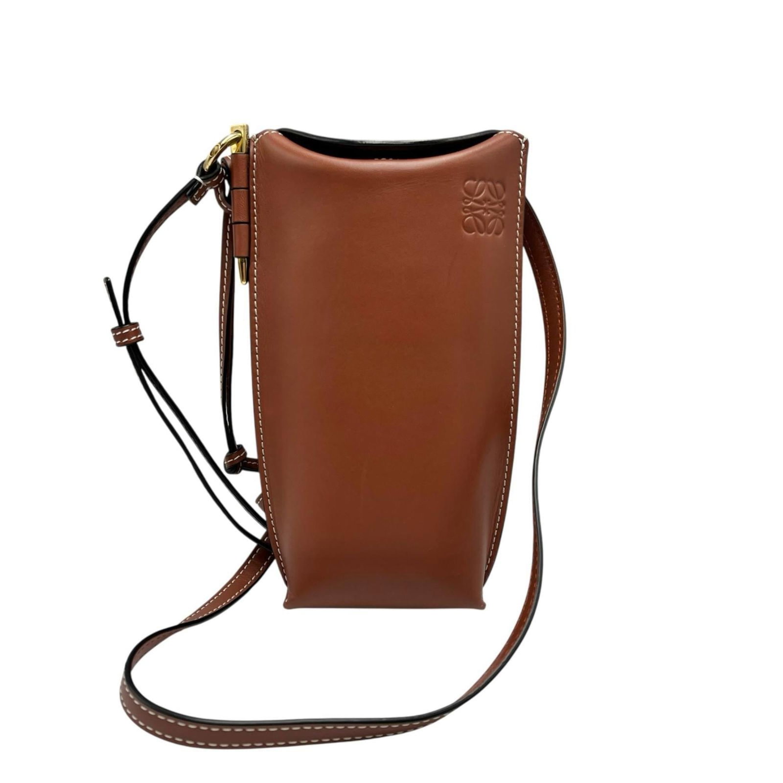 Loewe Leather Shoulder Bag: Loewe Leather Shoulder Bag A timeless piece from the iconic Spanish brand Loewe, this brown leather shoulder bag boasts classic sophistication with its clean lines and understated elegance. With its r