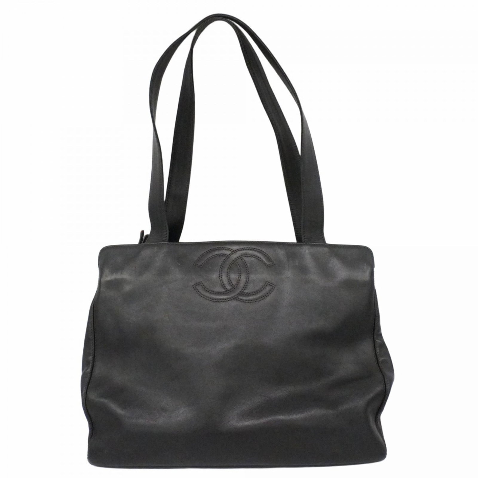 Leather Chanel Tote Bag: Leather Chanel Tote Bag A timeless and sophisticated black leather tote bag from the iconic Chanel brand, crafted from luxurious lambskin. With its classic design, gold hardware accents, and spacious