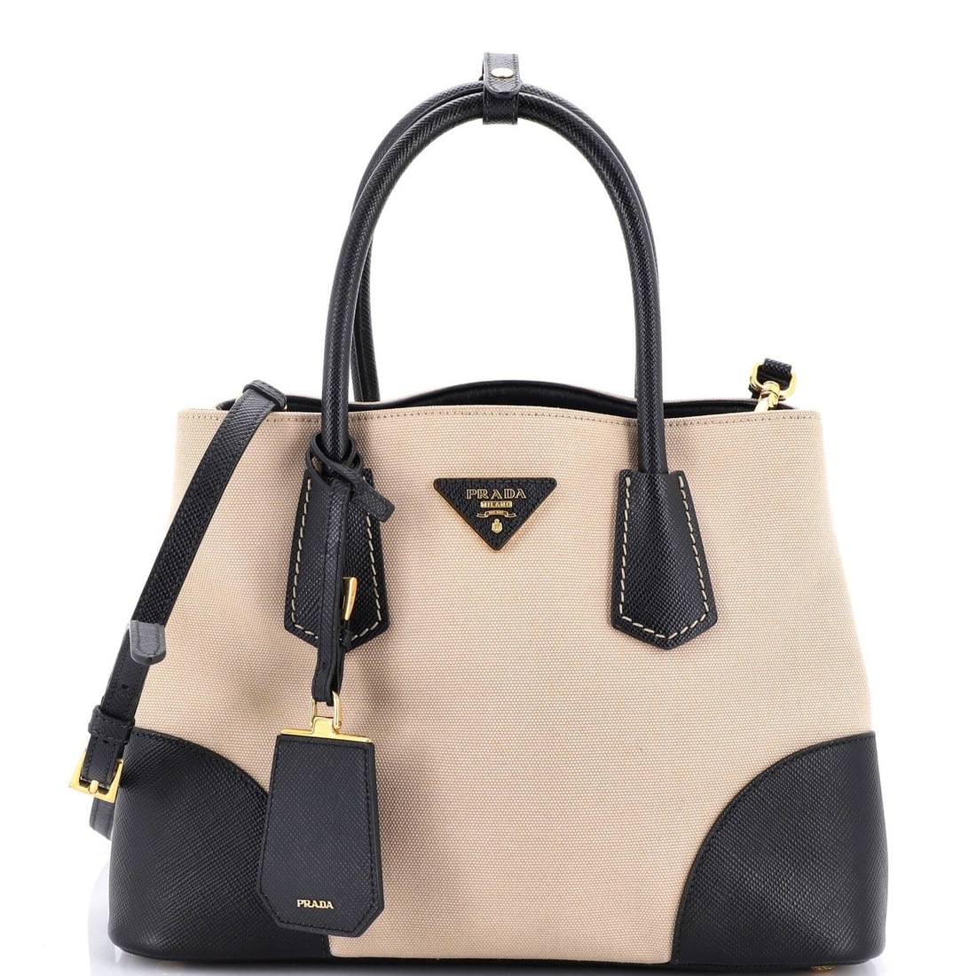 Prada Cuir Double Tote in Medium Canvas and Saffiano Leather: Prada Cuir Double Tote in Medium Canvas and Saffiano Leather The Prada Cuir Double Tote is a timeless and sophisticated accessory that combines the best of both worlds - medium canvas and saffiano lea