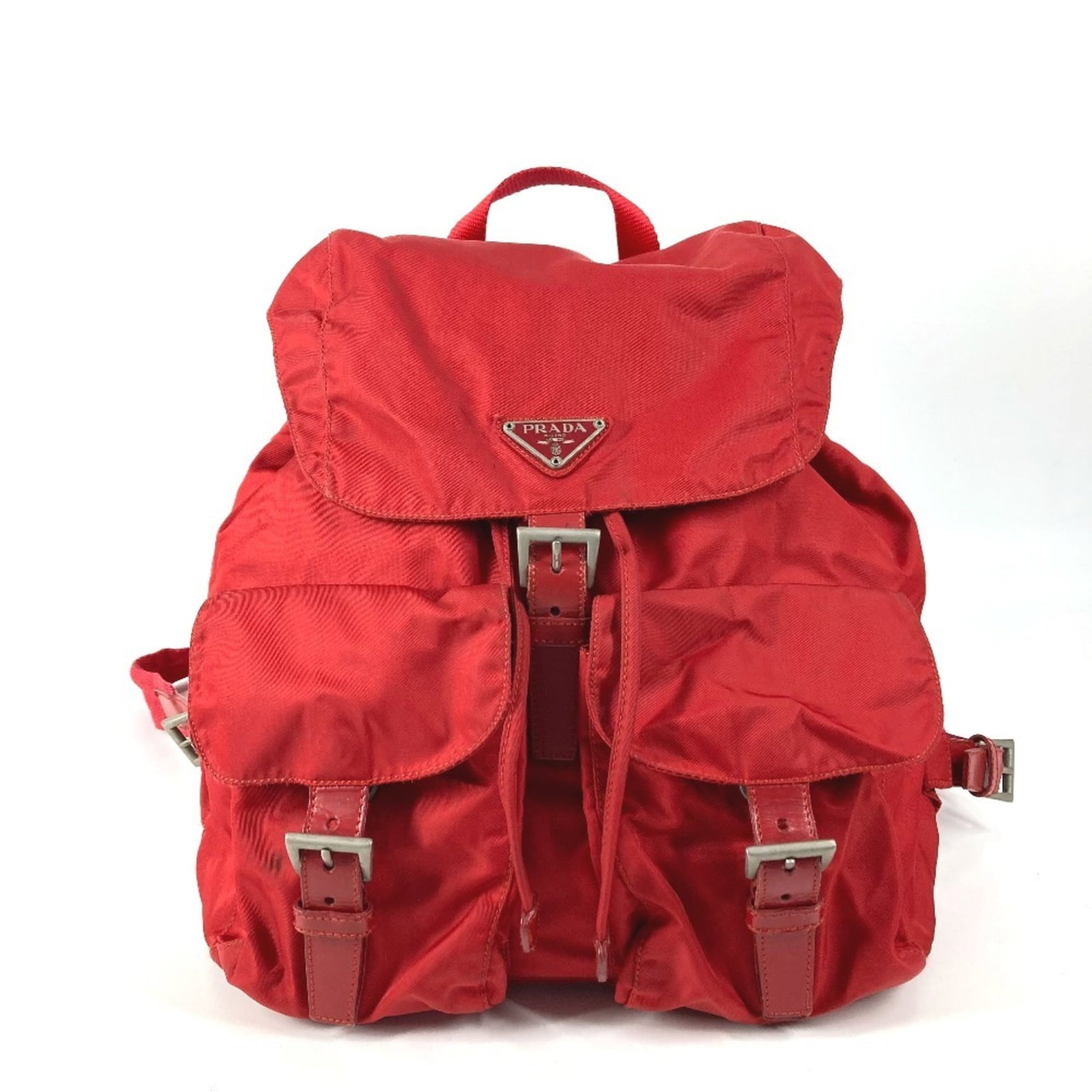 Prada Nylon Backpack: Prada Nylon Backpack A stylish and practical Prada Nylon Backpack in bold red, perfect for adding a pop of color to your daily commute or weekend adventures. With its durable nylon construction and cl