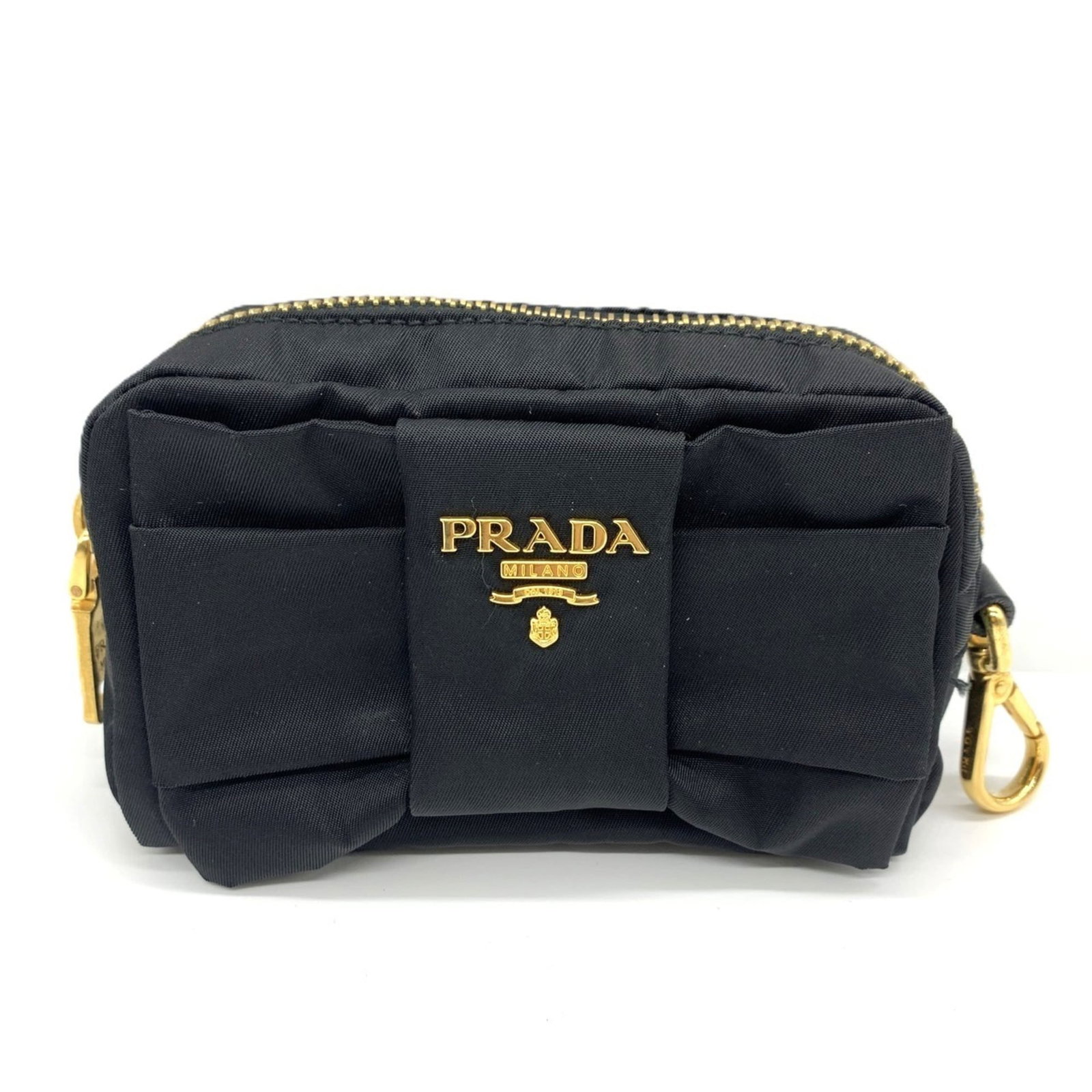 Prada Pouch in Nylon: Prada Pouch in Nylon A sleek and sophisticated Prada pouch in black nylon, this versatile accessory adds a touch of luxury to any outfit. With its zip closure and compact size, it's perfect for carryi