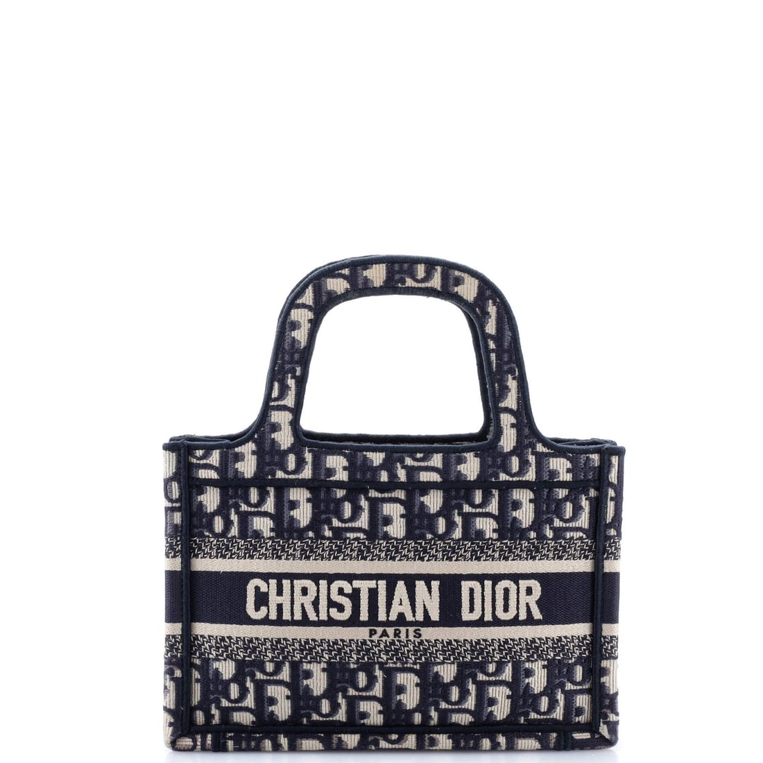 Christian Dior Mini Oblique Canvas Book Tote: Christian Dior Mini Oblique Canvas Book Tote Add a touch of French chic to your daily routine with this stunning Christian Dior Mini Oblique Canvas Book Tote. Made from high-quality canvas, this compa
