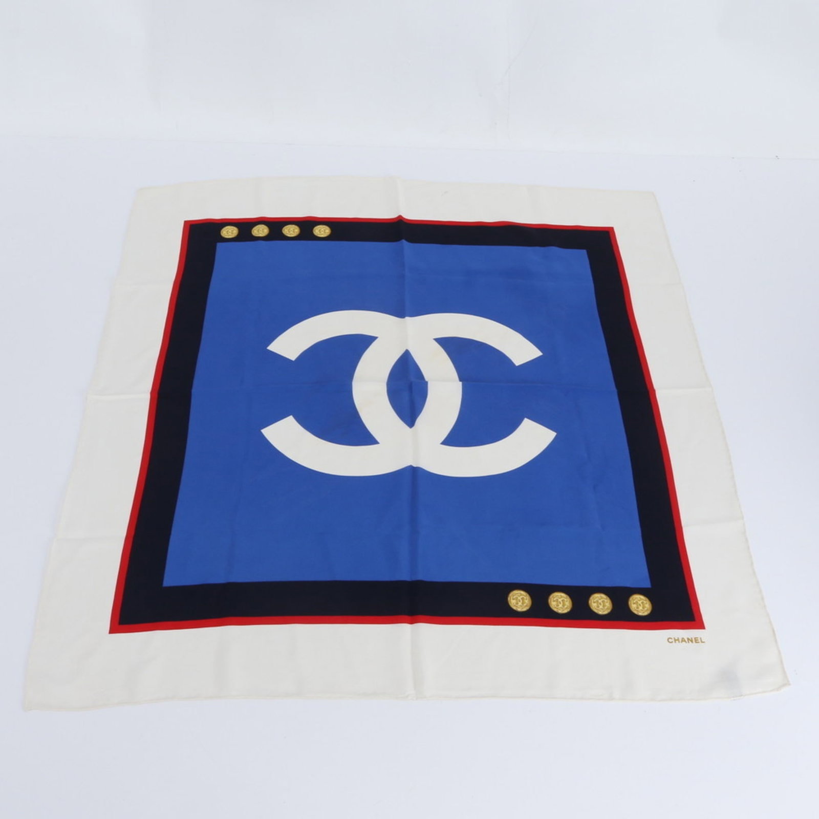 Chanel Silk Scarf: Chanel Silk Scarf A stunning piece of luxury, this pre-owned Chanel silk scarf boasts the iconic brand's signature blue hue and exquisite silk material, evoking the elegance of a bygone era. With its