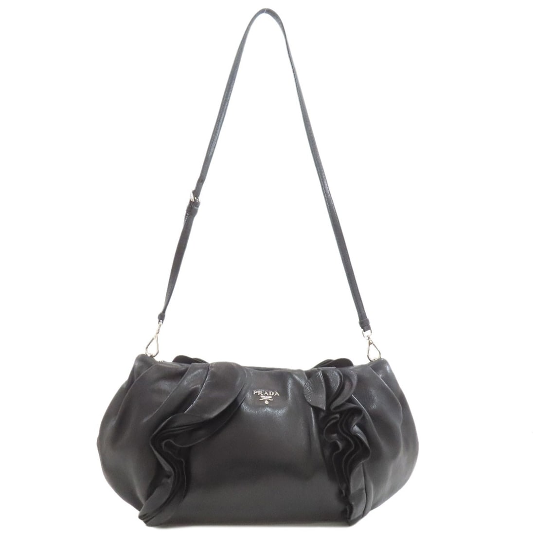 Prada Lambskin Frill Shoulder Bag: Prada Lambskin Frill Shoulder Bag Elevate your style with the timeless Prada Lambskin Frill Shoulder Bag, crafted from luxurious lambskin and adorned with a delicate frill detail that adds a touch of