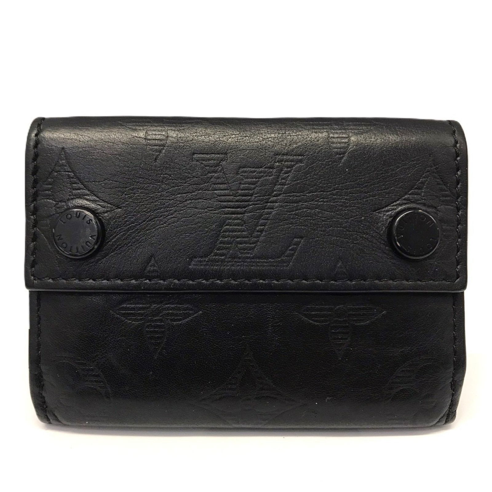 Louis Vuitton Tri-Fold Monogram Shadow Wallet: Louis Vuitton Tri-Fold Monogram Shadow Wallet A sleek and sophisticated accessory for the modern gentleman, this Louis Vuitton Tri-Fold Monogram Shadow Wallet boasts the iconic brand's signature monog