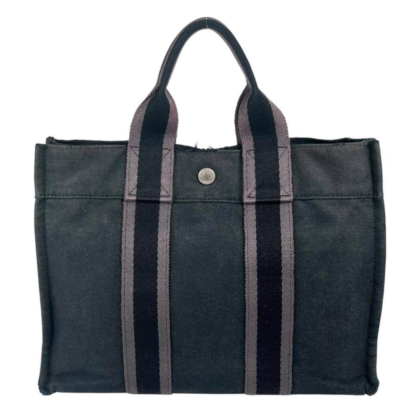 Hermes Canvas Tote Bag: Hermes Canvas Tote Bag A pre-owned Hermes canvas tote bag, offering a timeless and versatile accessory for everyday use. With its classic black color and durable canvas material, this bag is perfect f