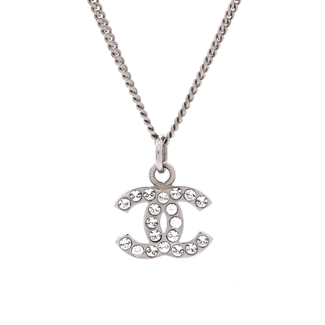 Chanel Crystal CC Logo Necklace in Metal: Chanel Crystal CC Logo Necklace in Metal Elevate your style with the iconic Chanel Crystal CC Logo Necklace, boasting sleek silver metal and a timeless crystal logo design that exudes luxury and sophi