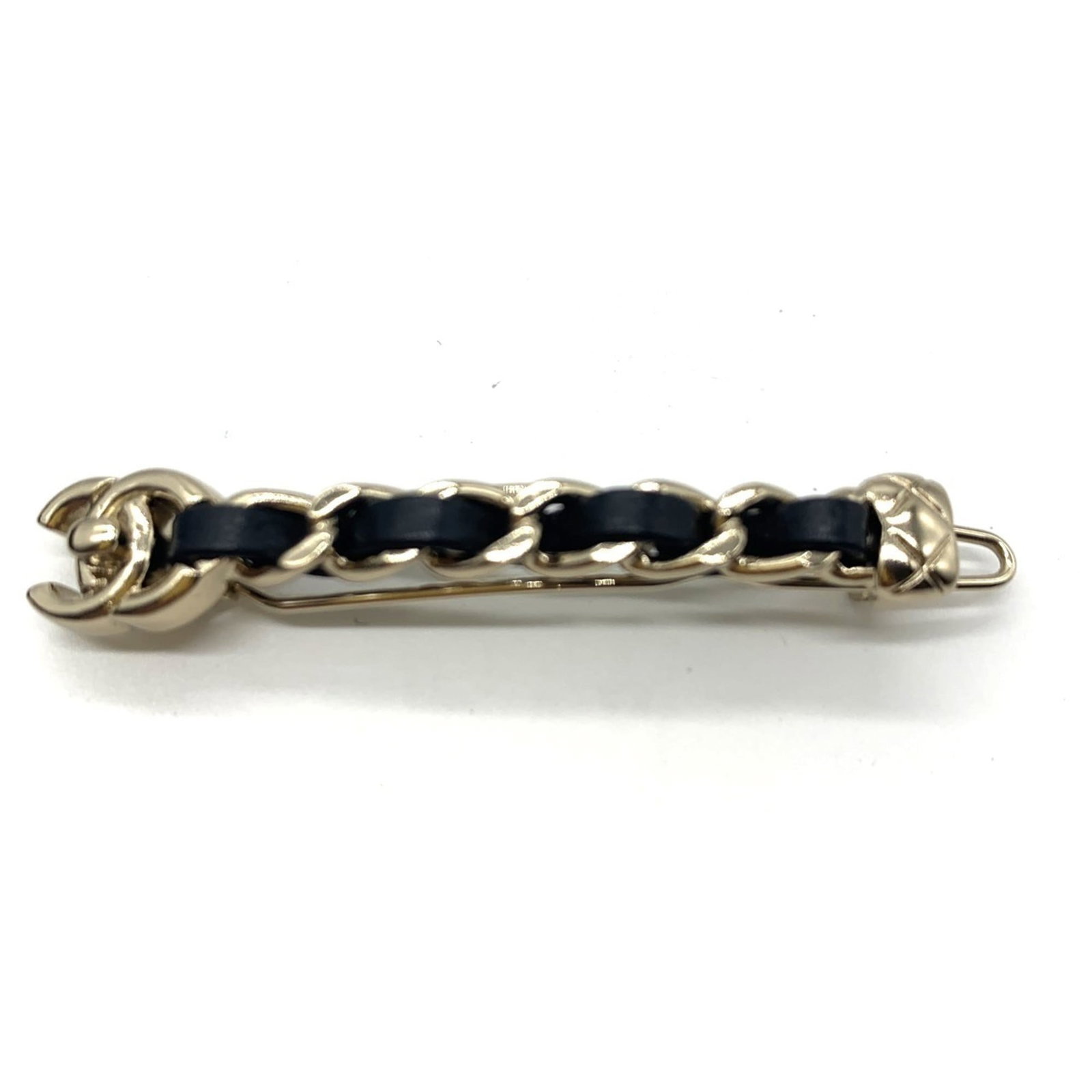 Chanel Barrette in Leather and Metal: Chanel Barrette in Leather and Metal A sleek and sophisticated Chanel barrette, crafted from luxurious leather and metallic accents, adds a touch of timeless elegance to any hairstyle. With its classi