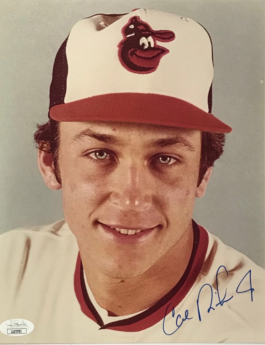 (JSA) Cal Ripken Jr. Autographed 8x10 Baseball Photo: (JSA) Cal Ripken Jr. Autographed 8x10 Baseball Photo Get ready to own a piece of baseball history with this authentic 8x10 photo signed by the legendary Cal Ripken Jr. in blue sharpie, authenticated b