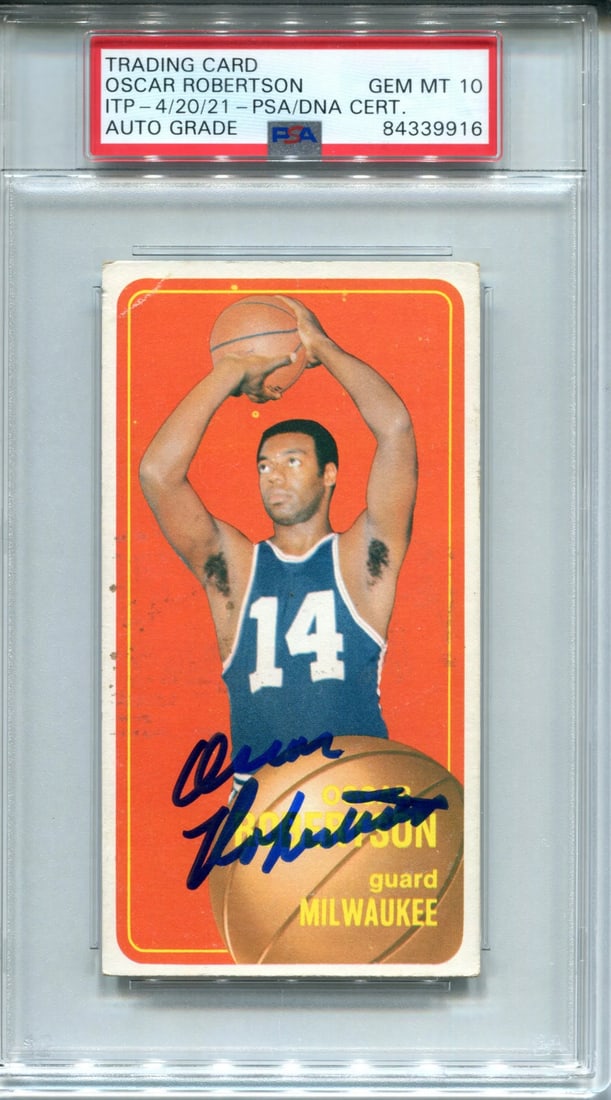 (PSA) Oscar Robertson Autographed 1970-71 Topps Card #100: (PSA) Oscar Robertson Autographed 1970-71 Topps Card #100 Experience the iconic style of basketball legend Oscar Robertson, signed in blue sharpie across his 1970-71 Topps Card #100. Authenticated by